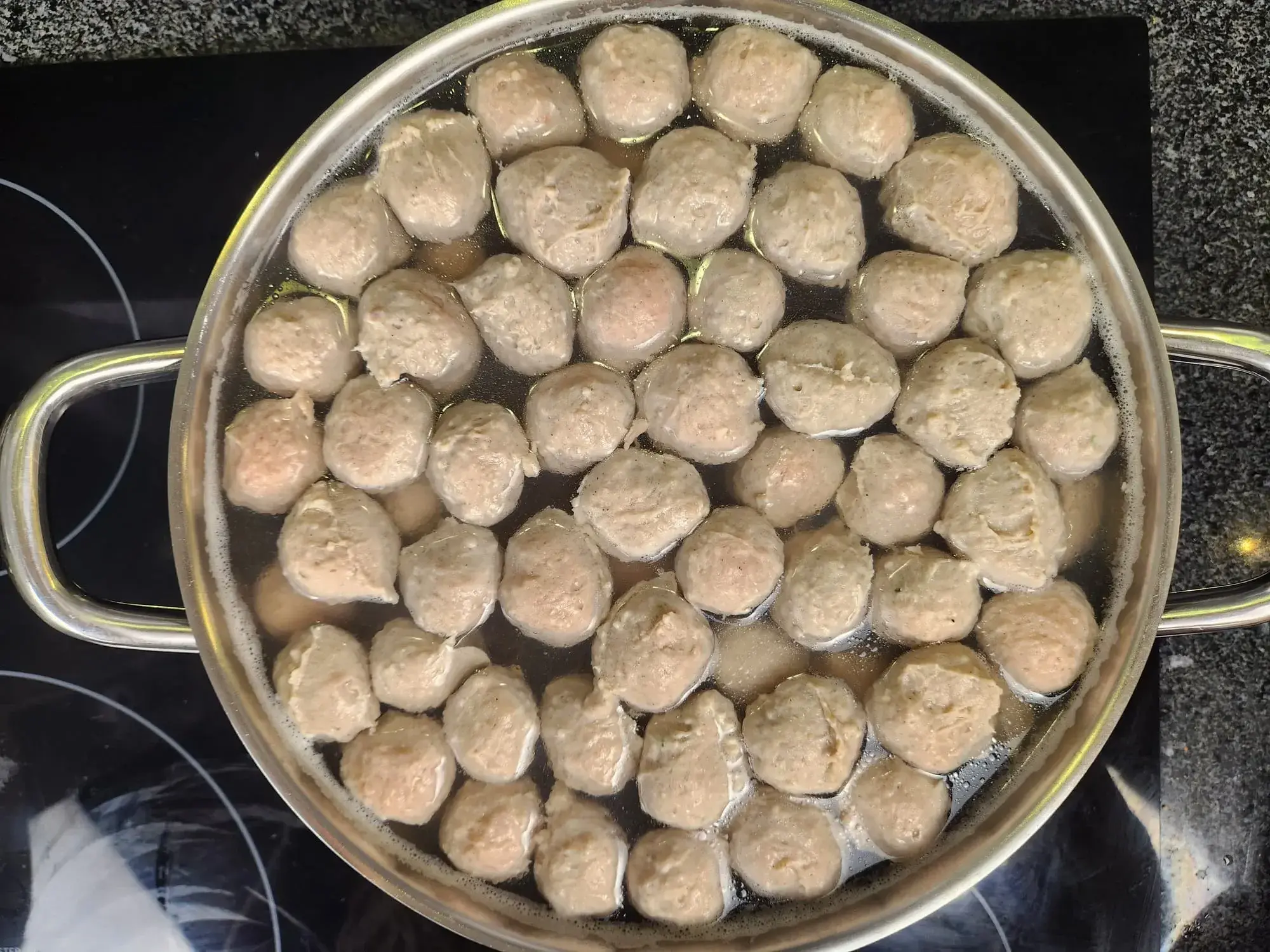 Simmer until the meatballs are cooked. The meatballs will float to the surface when done (if unsure, cut one open to check the inside).