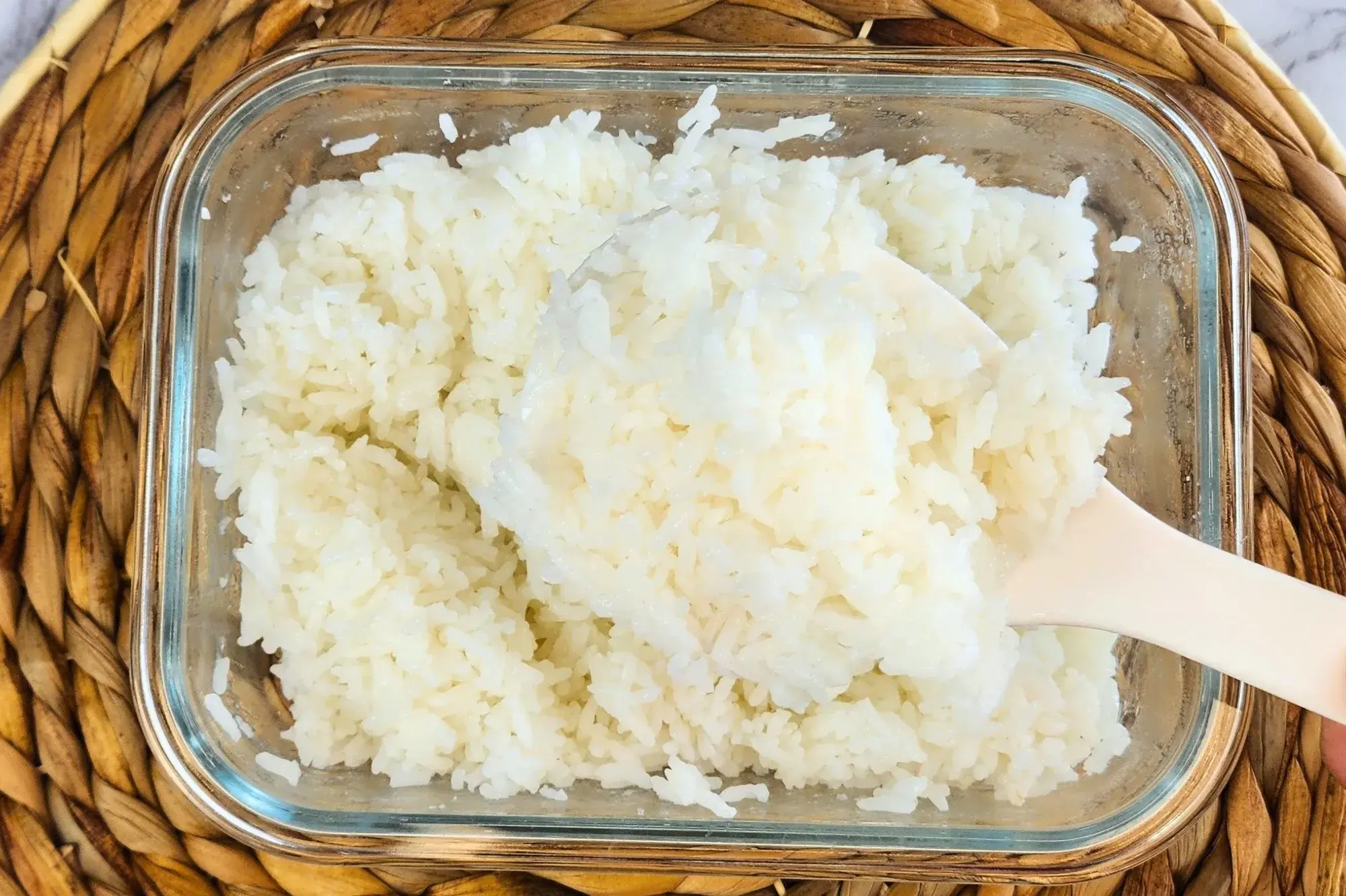A big spoon is in jasmine rice container