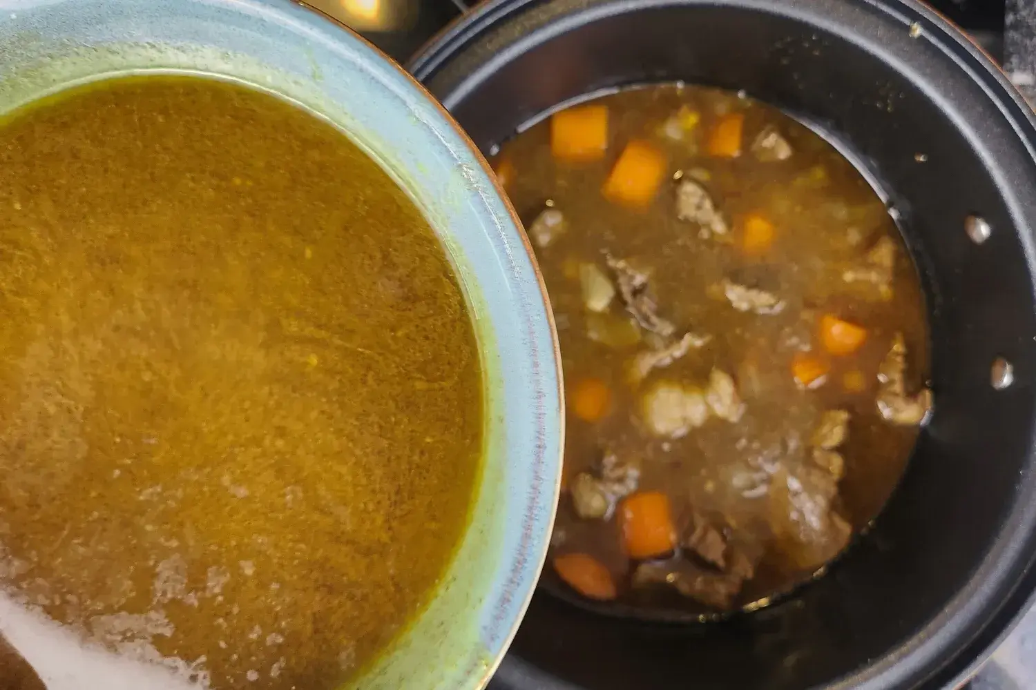 A bowl of broth above a pot with melted butter.