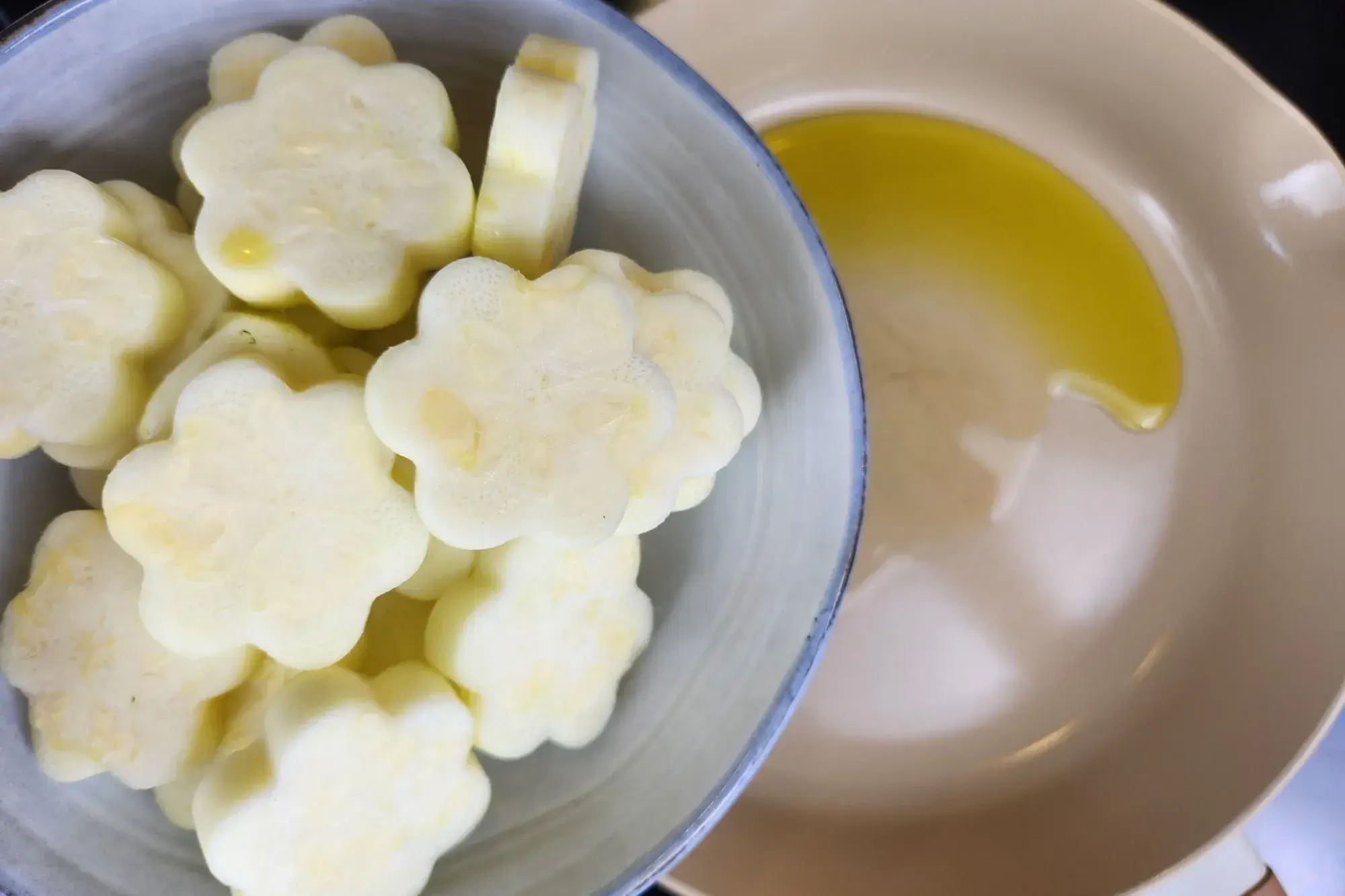 A bowl of center of zucchini above a pan