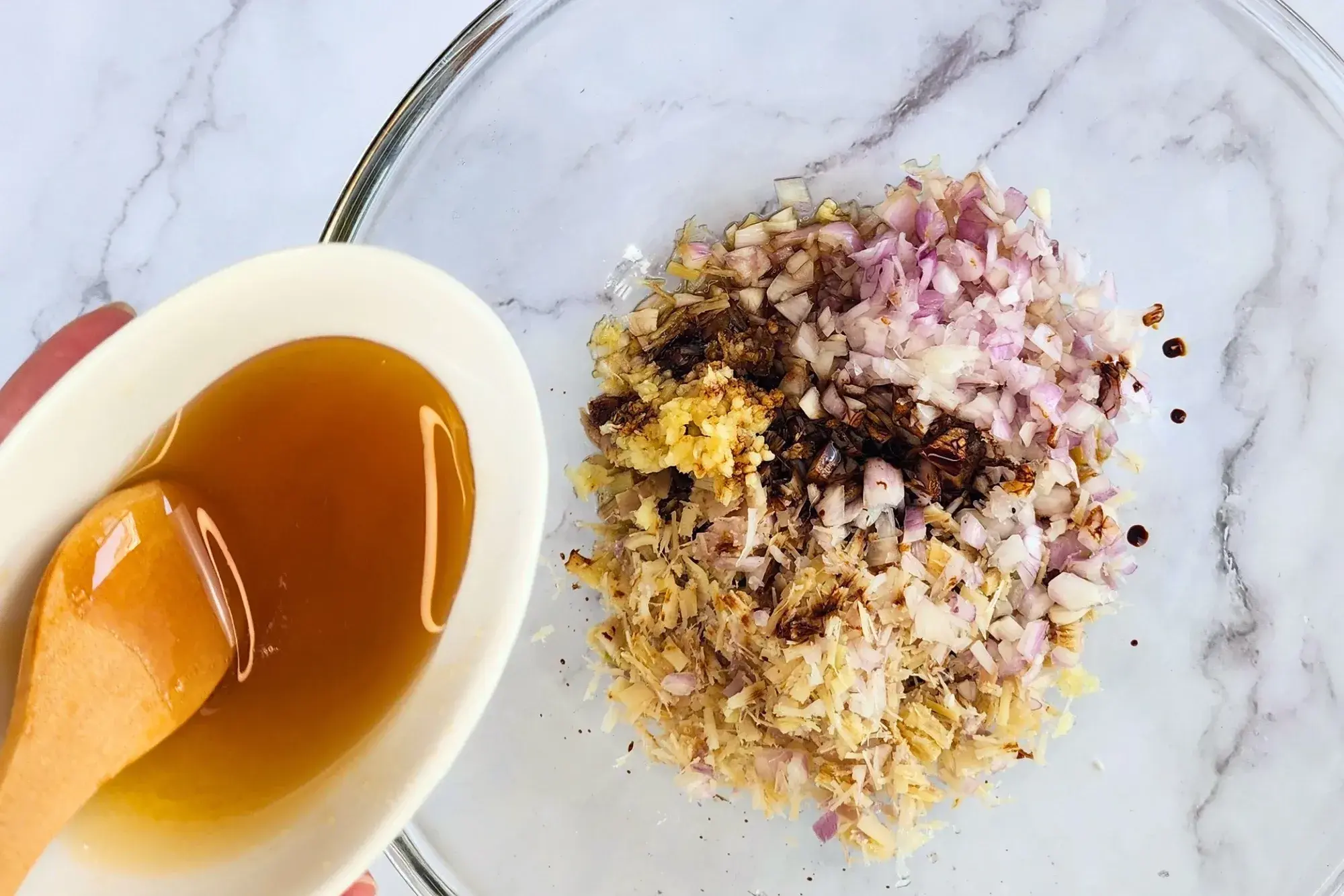 A bowl of honey above a mixing bowl