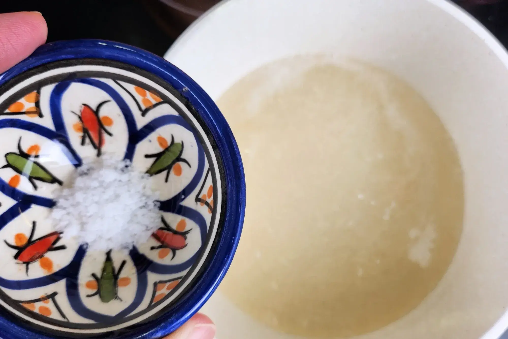 A bowl of salt above a pot
