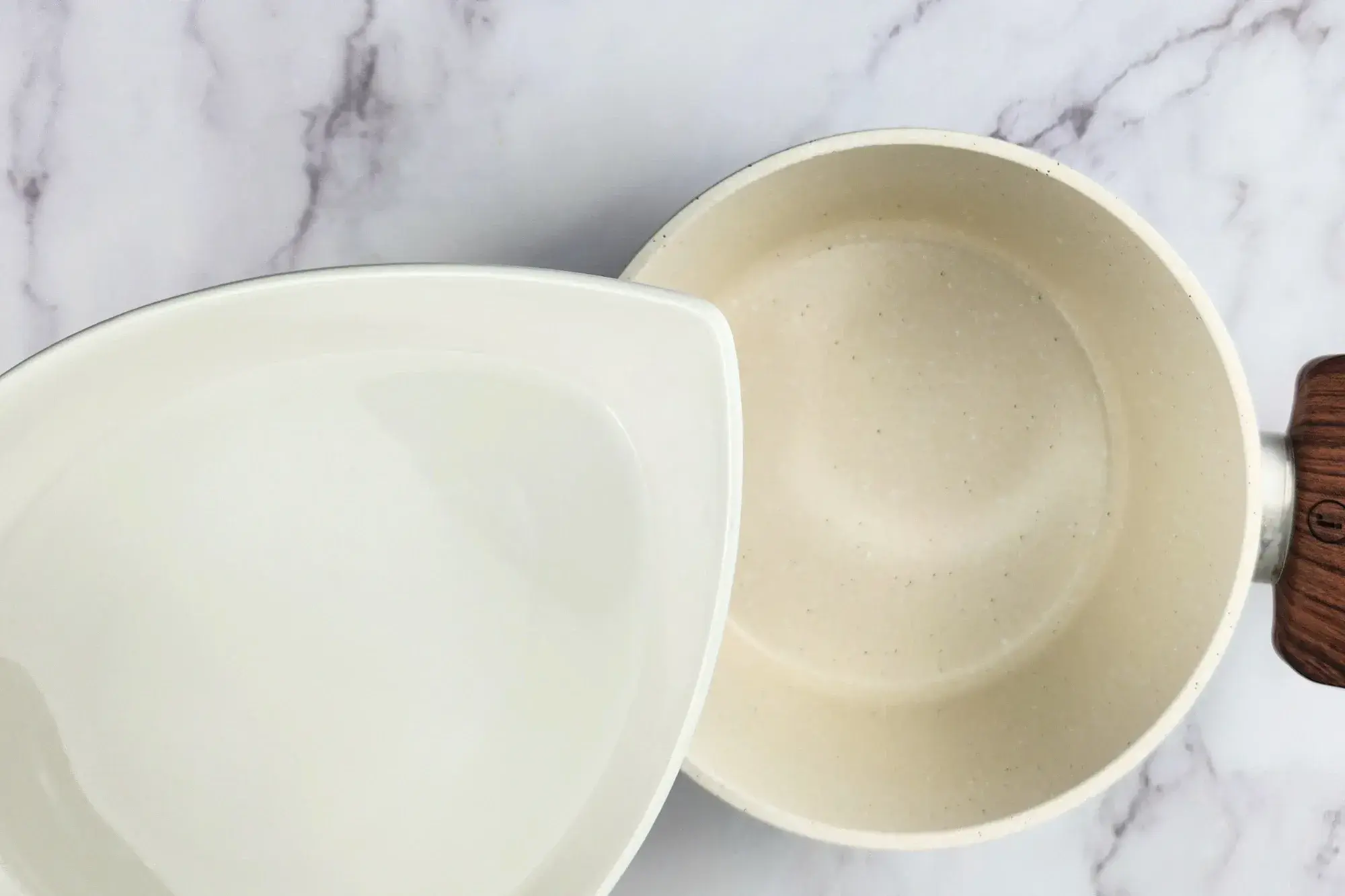 A bowl of water above a pot