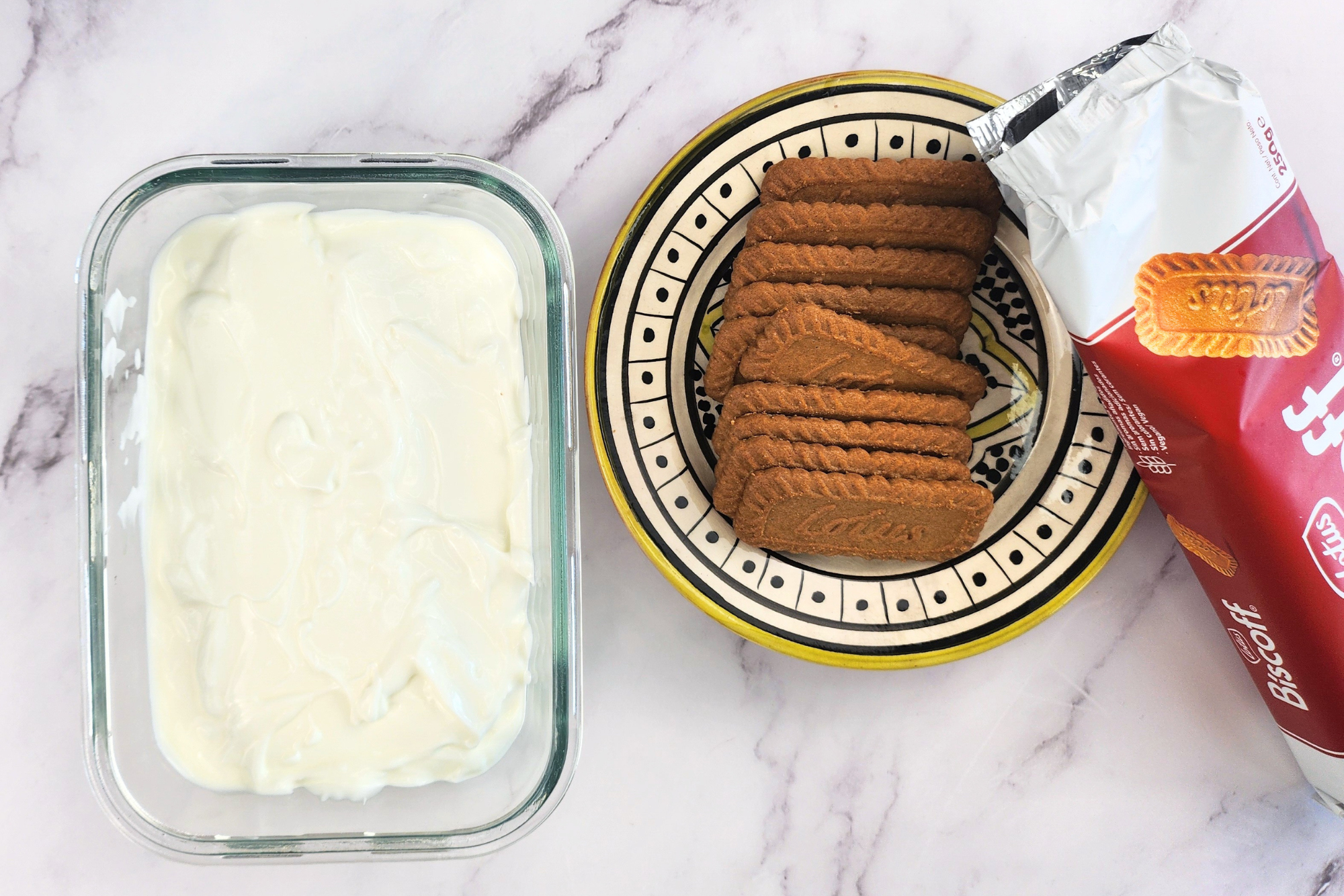 A bowl of yogurt and a plate of cookies.