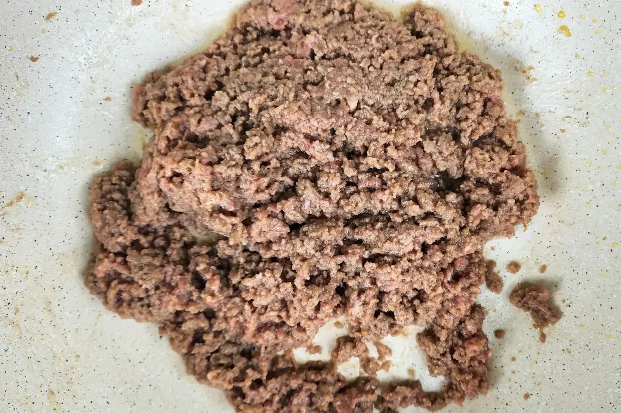 A cooked ground beef in a wok.