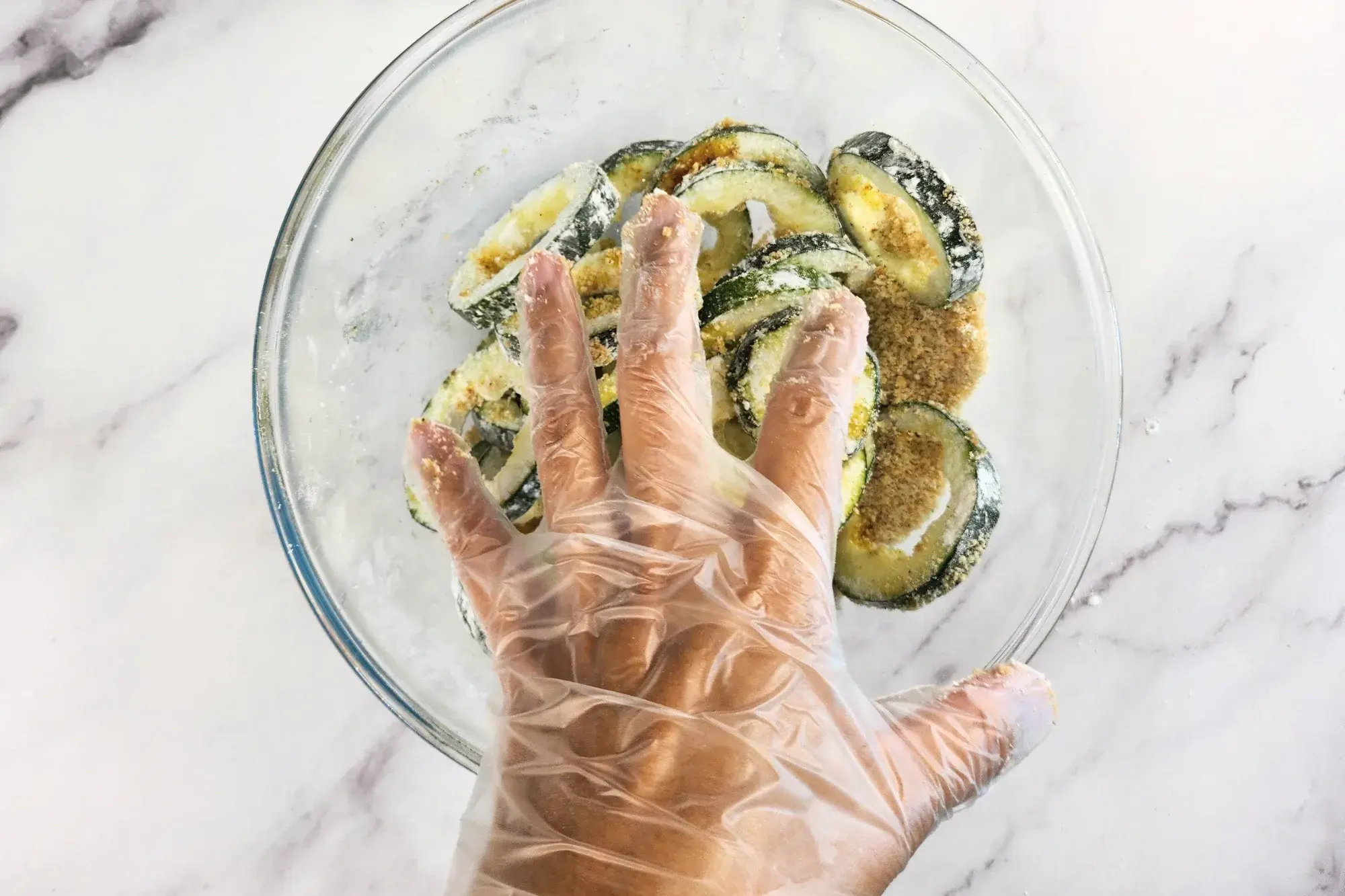 A hand above a mixing bowl