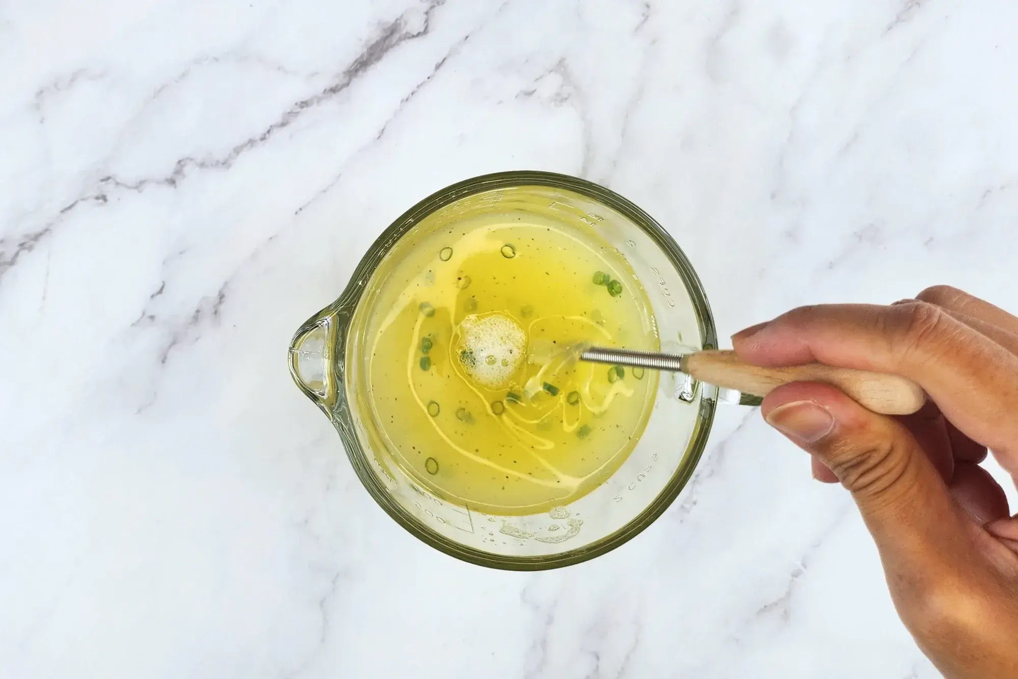 A hand stiring egg white