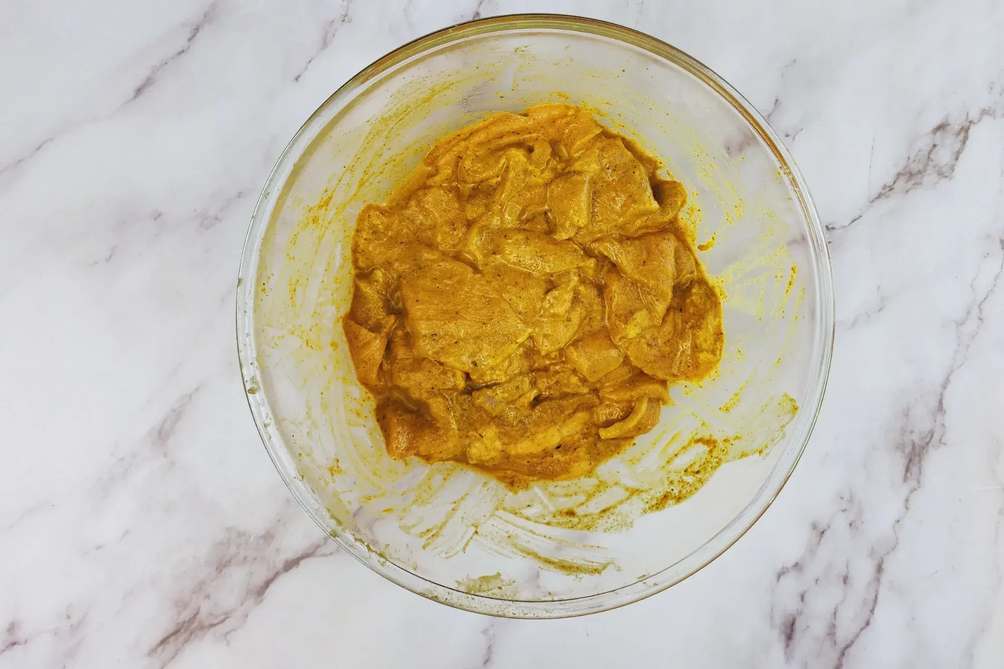 A mixing bowl with pork marinated