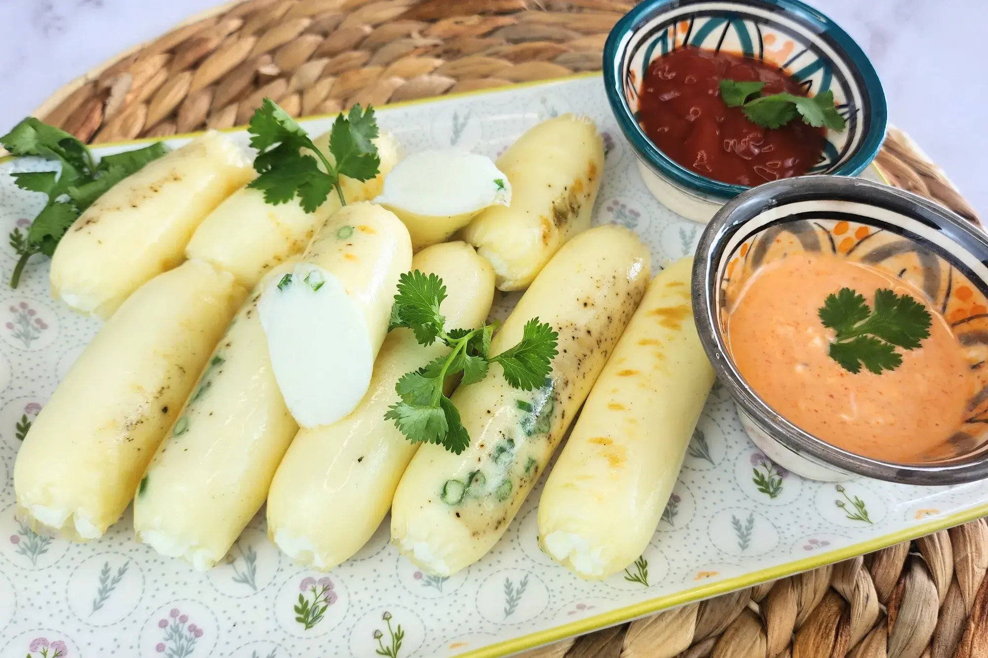 A plated of grilled sausages with two dipping sauces