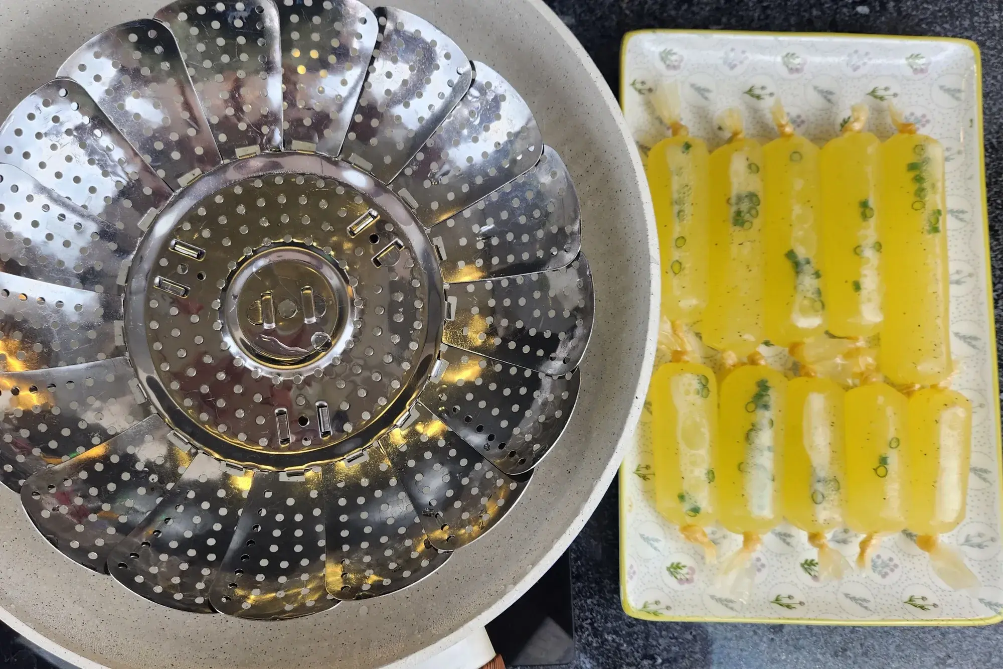 A steaming pot with uncooked sausages