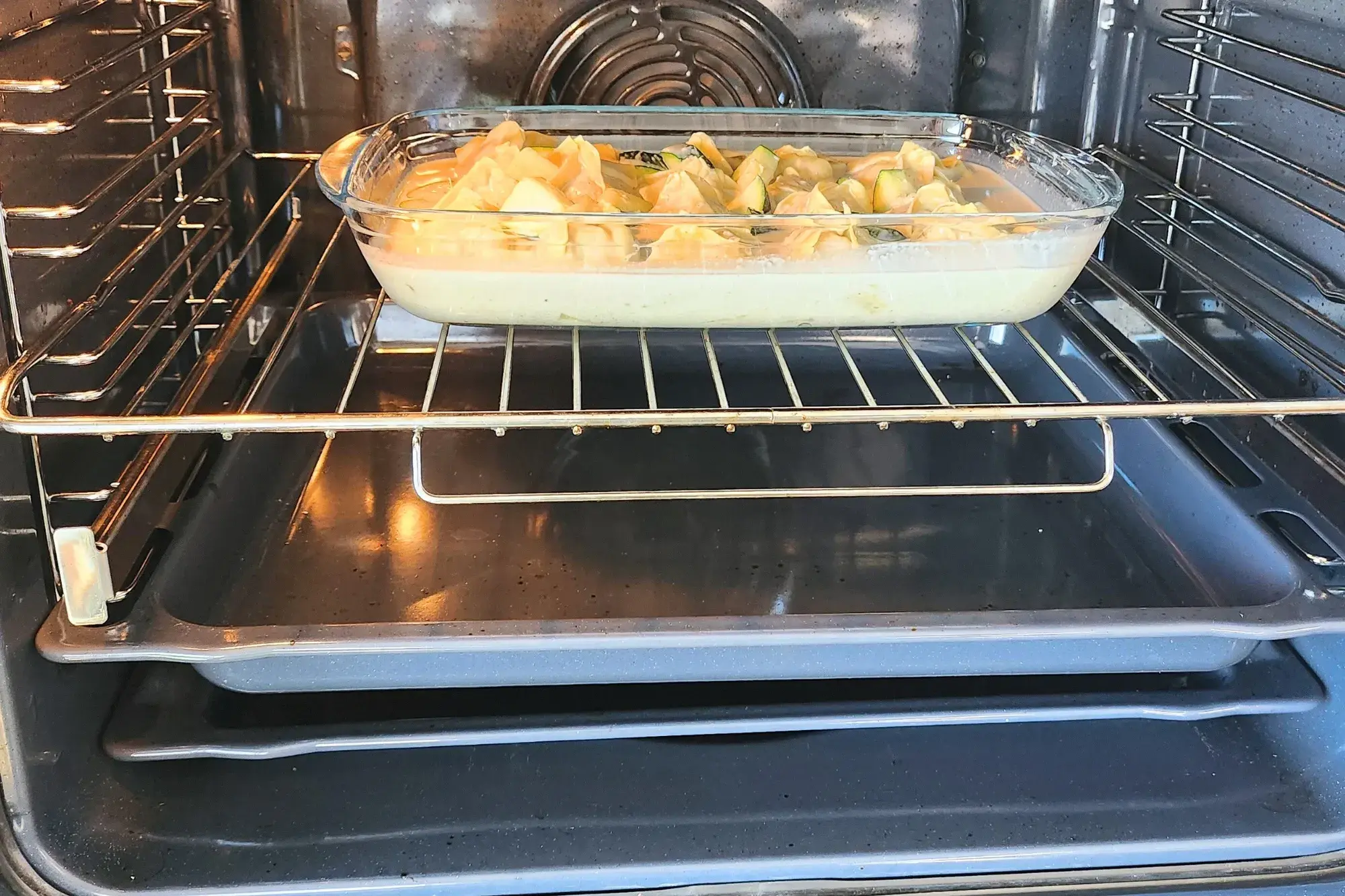 A  tray of food is in an oven.