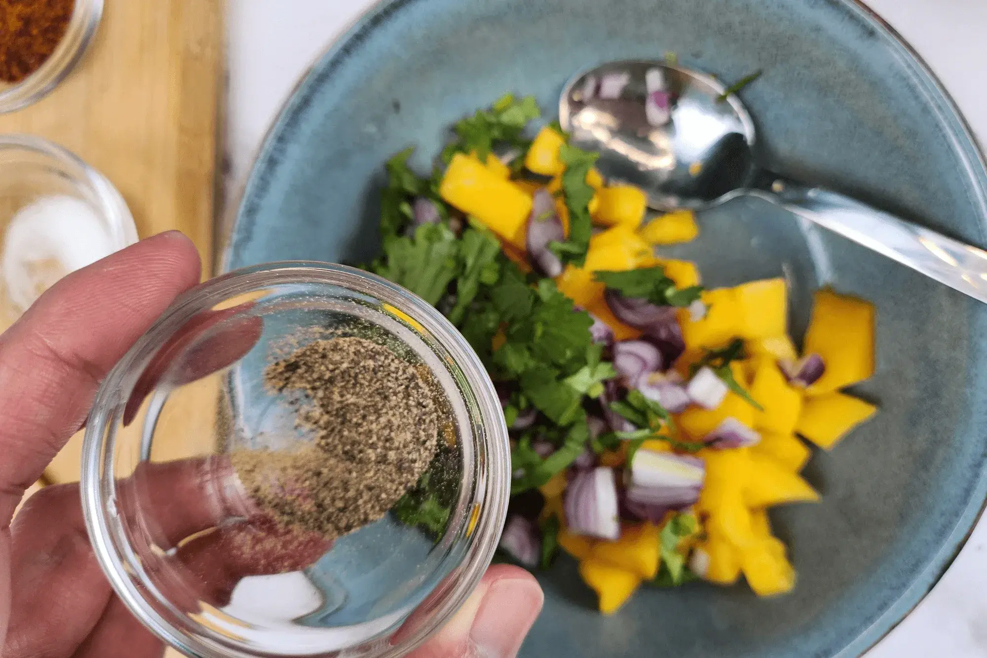 Add black pepper into mango salad