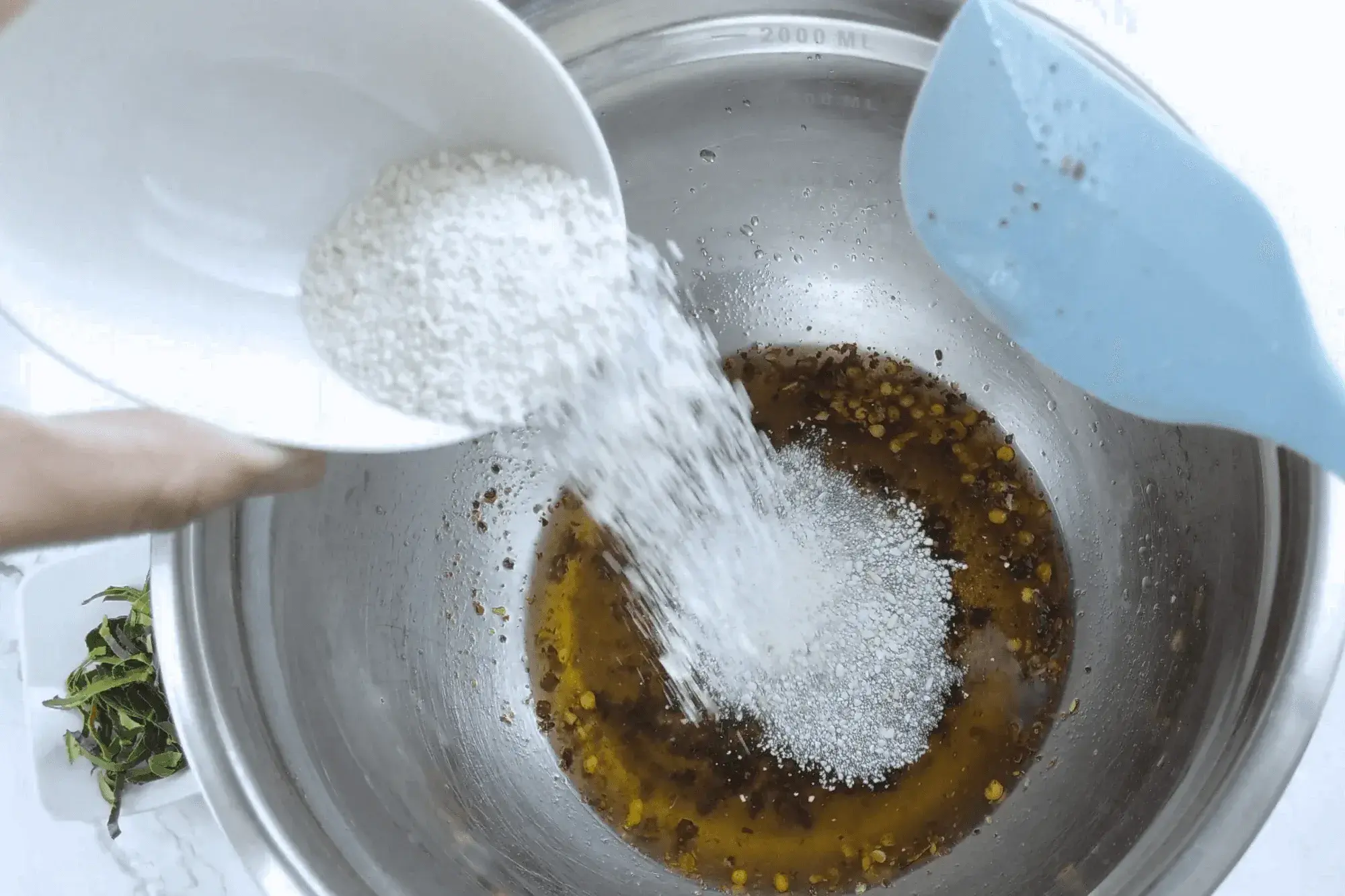 Add chili powder and toasted rice powder to the dressing.