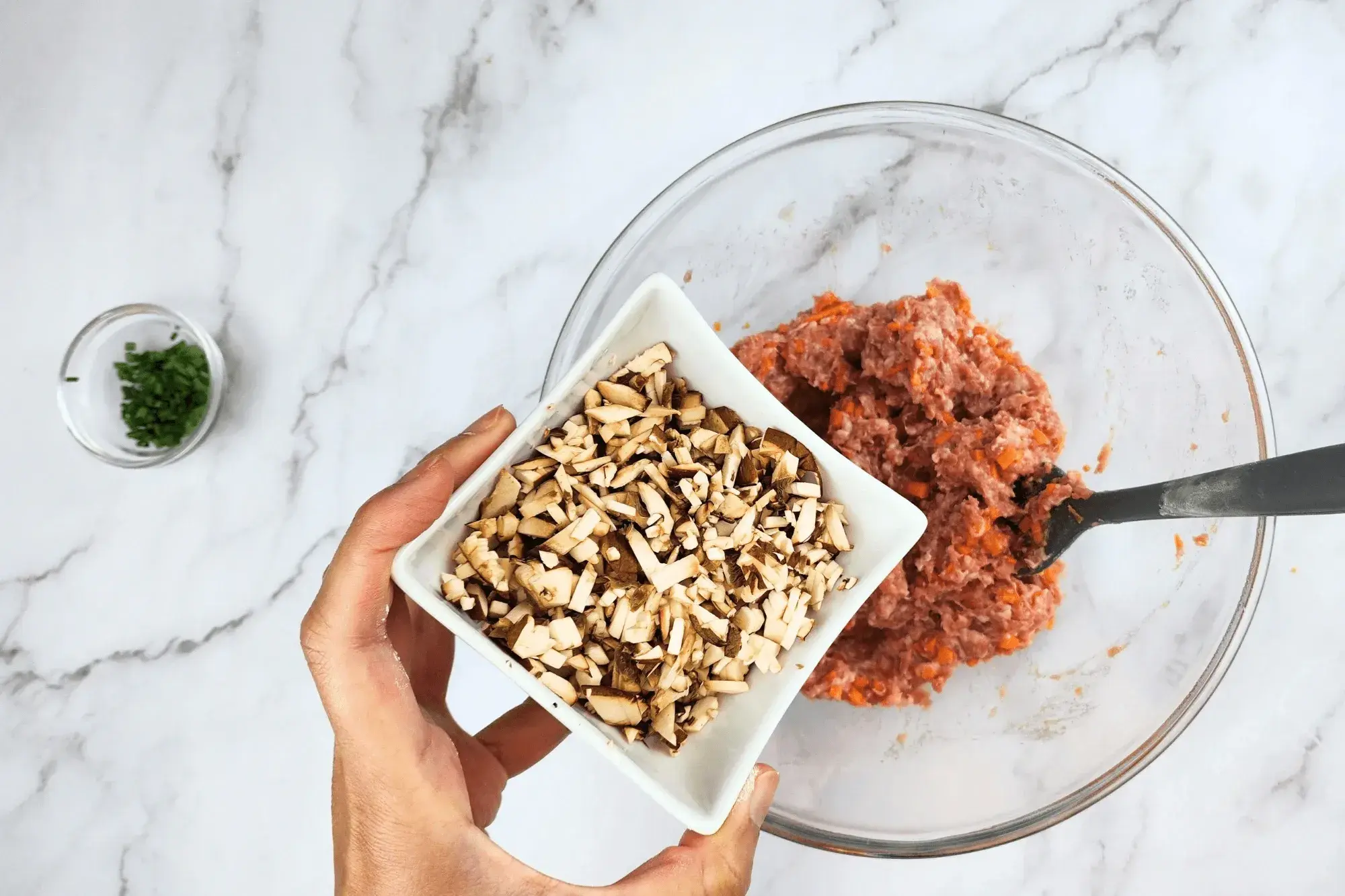 Finely diced mushrooms with mixing bowl