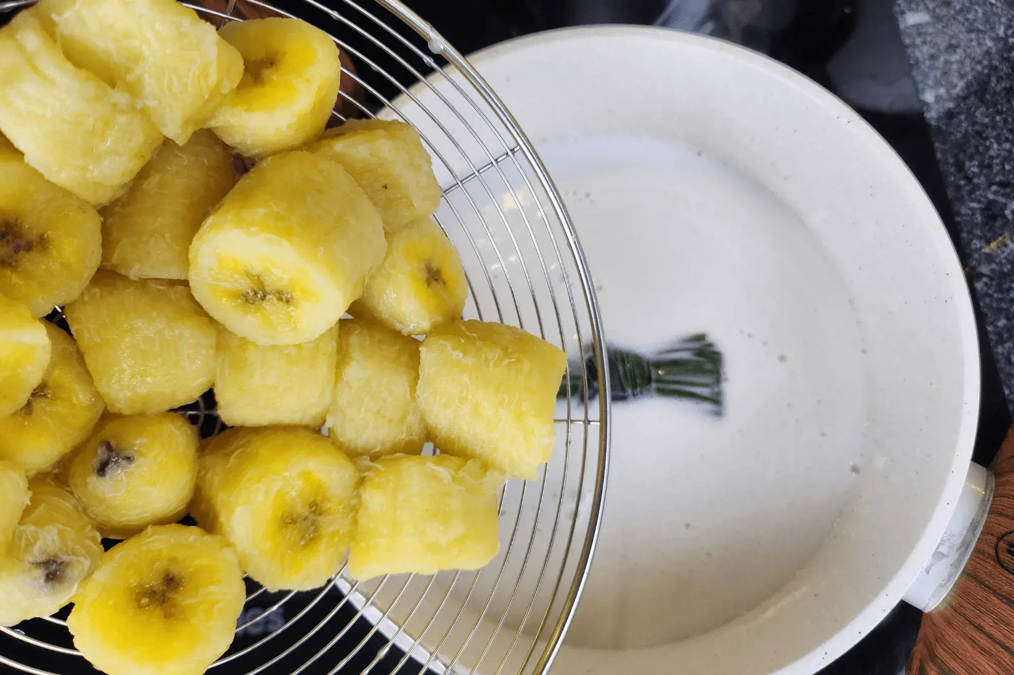 Add the cooked bananas to the coconut milk mixture and gently stir.