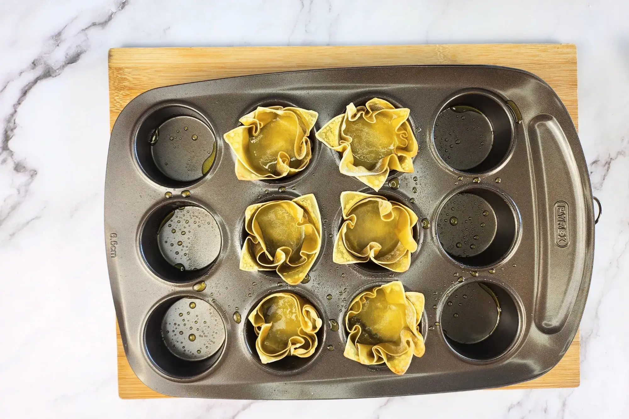 Baked six wonton cup in muffin tray.