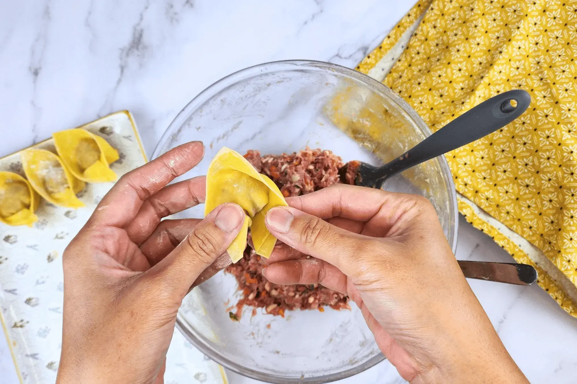 Bring the two ends of wrapper triangle shape together