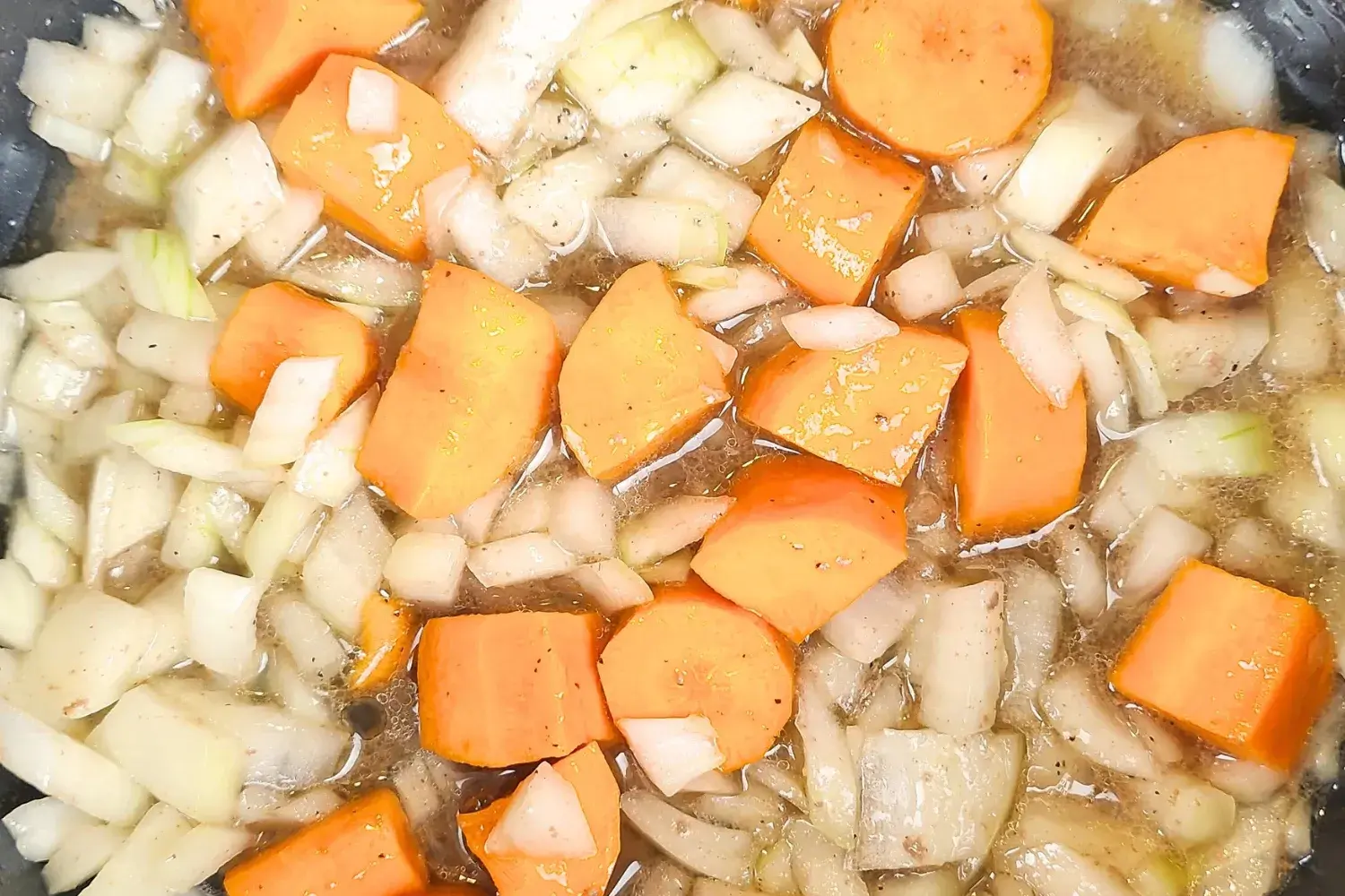 Cooking carrots and onions.