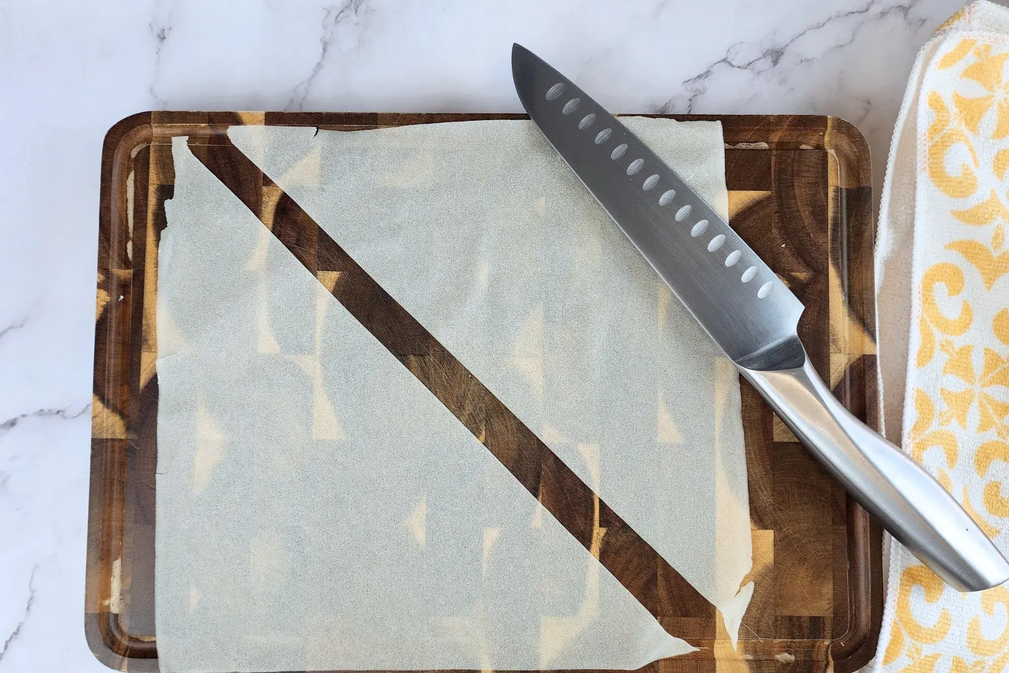 Cut the samosa sheets into triangle strips.