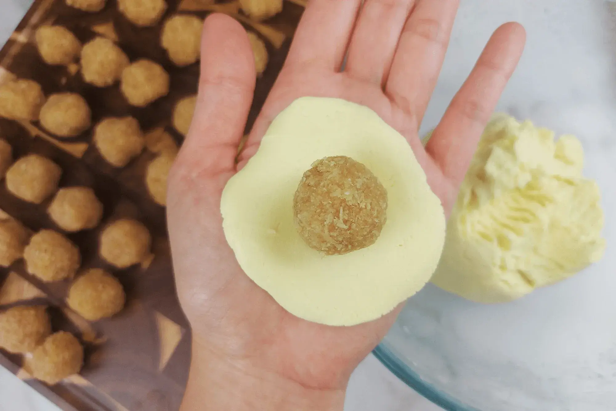 Flatten a portion of the dough and place the filling in the center.