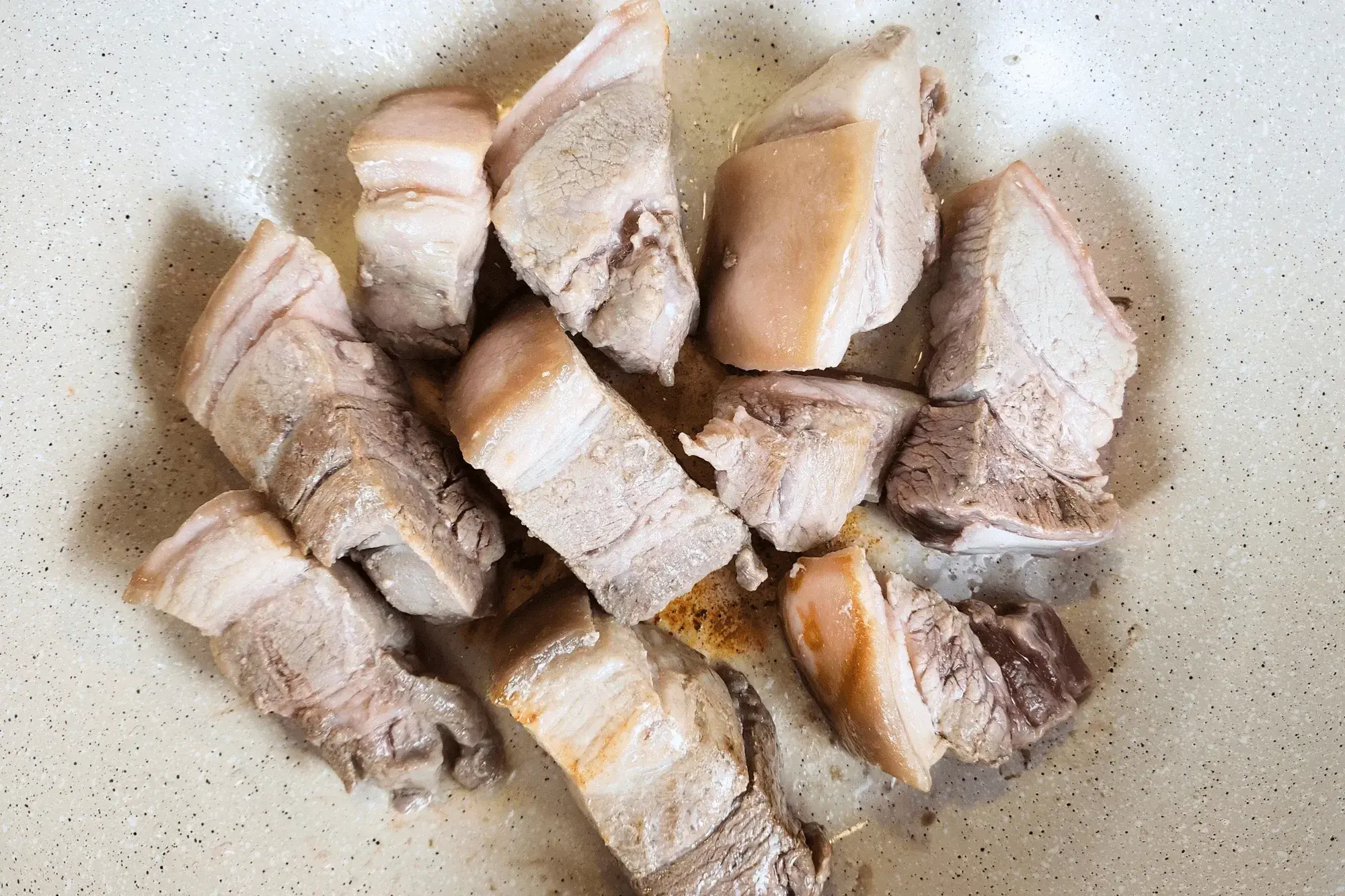 half cooked pork belly in the wok