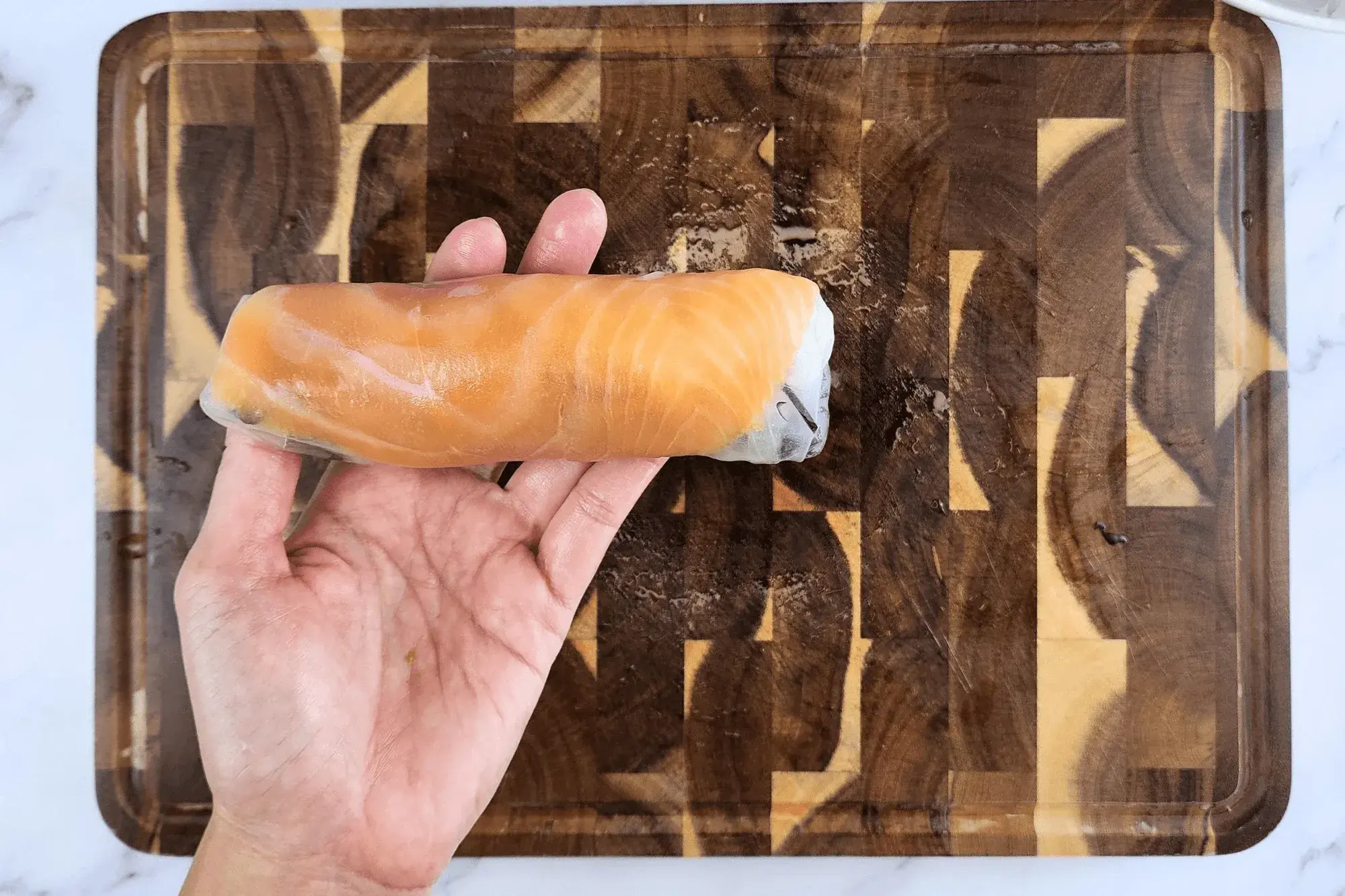 Holding Summer Salad Rolls with Smoked Salmon