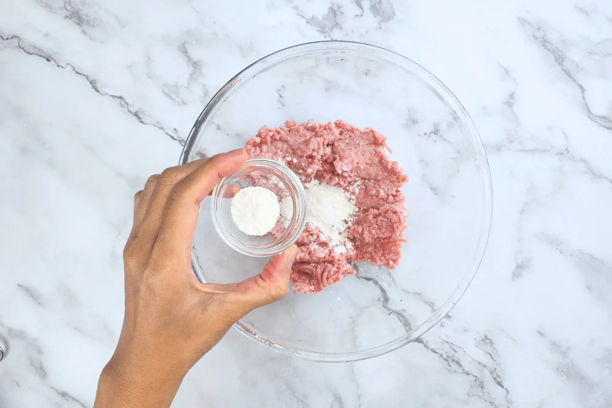 In a bowl, combine ground pork with cornstarch, baking soda