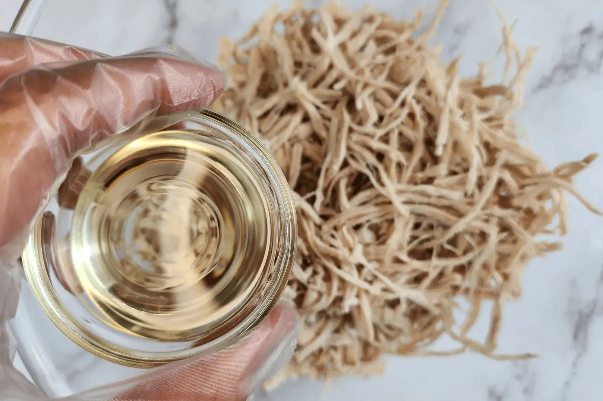 In a bowl, mix the shredded pork with sugar, fish sauce, and vegetable oil. 