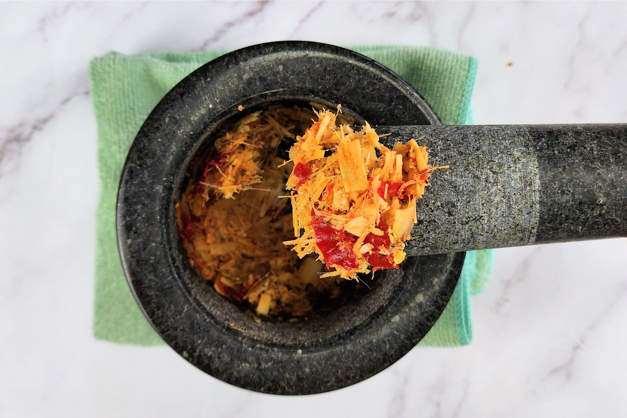 Lemongrass chili paste is in a mortar.