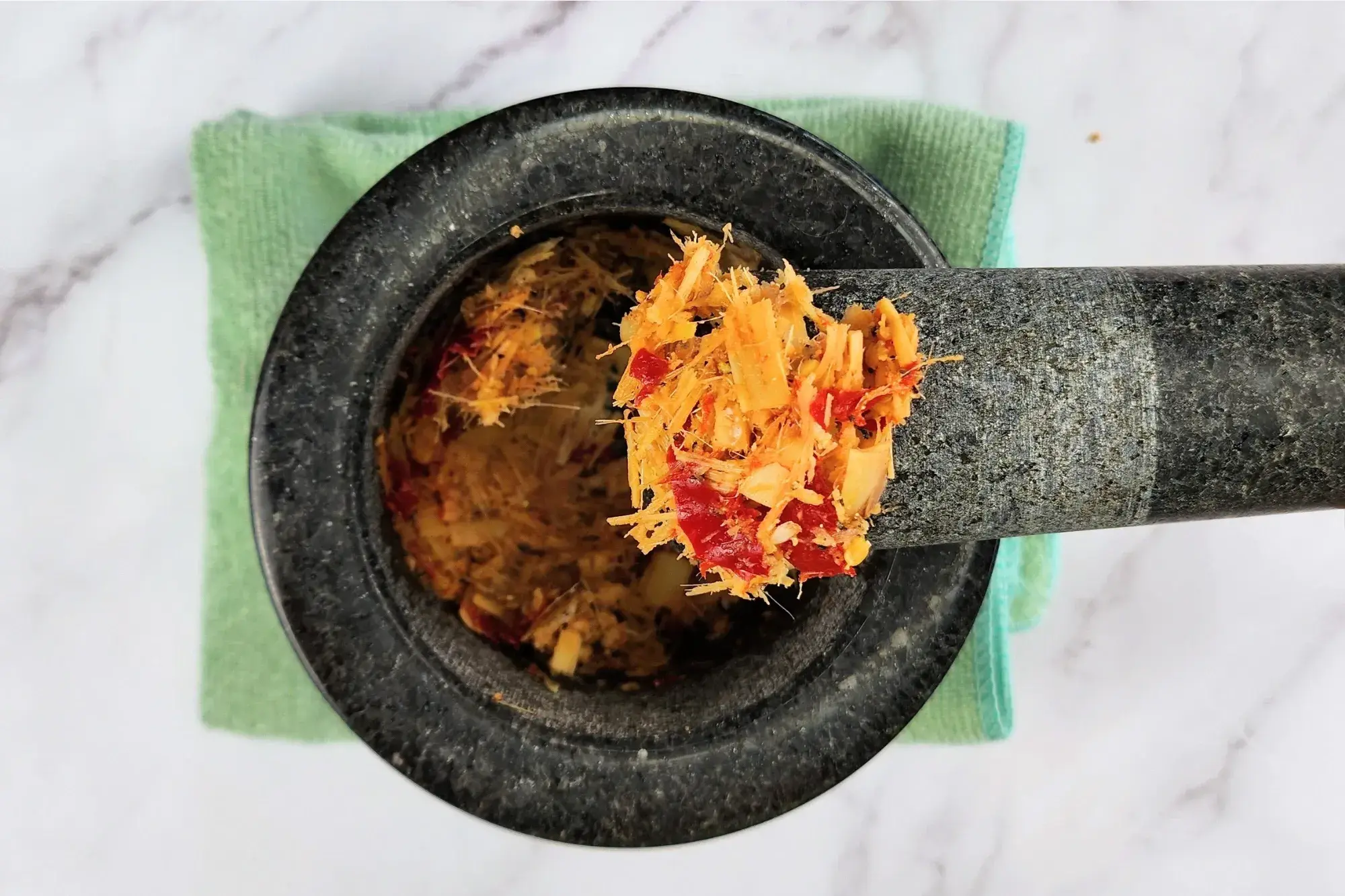 Lemongrass chili paste is in a mortar.