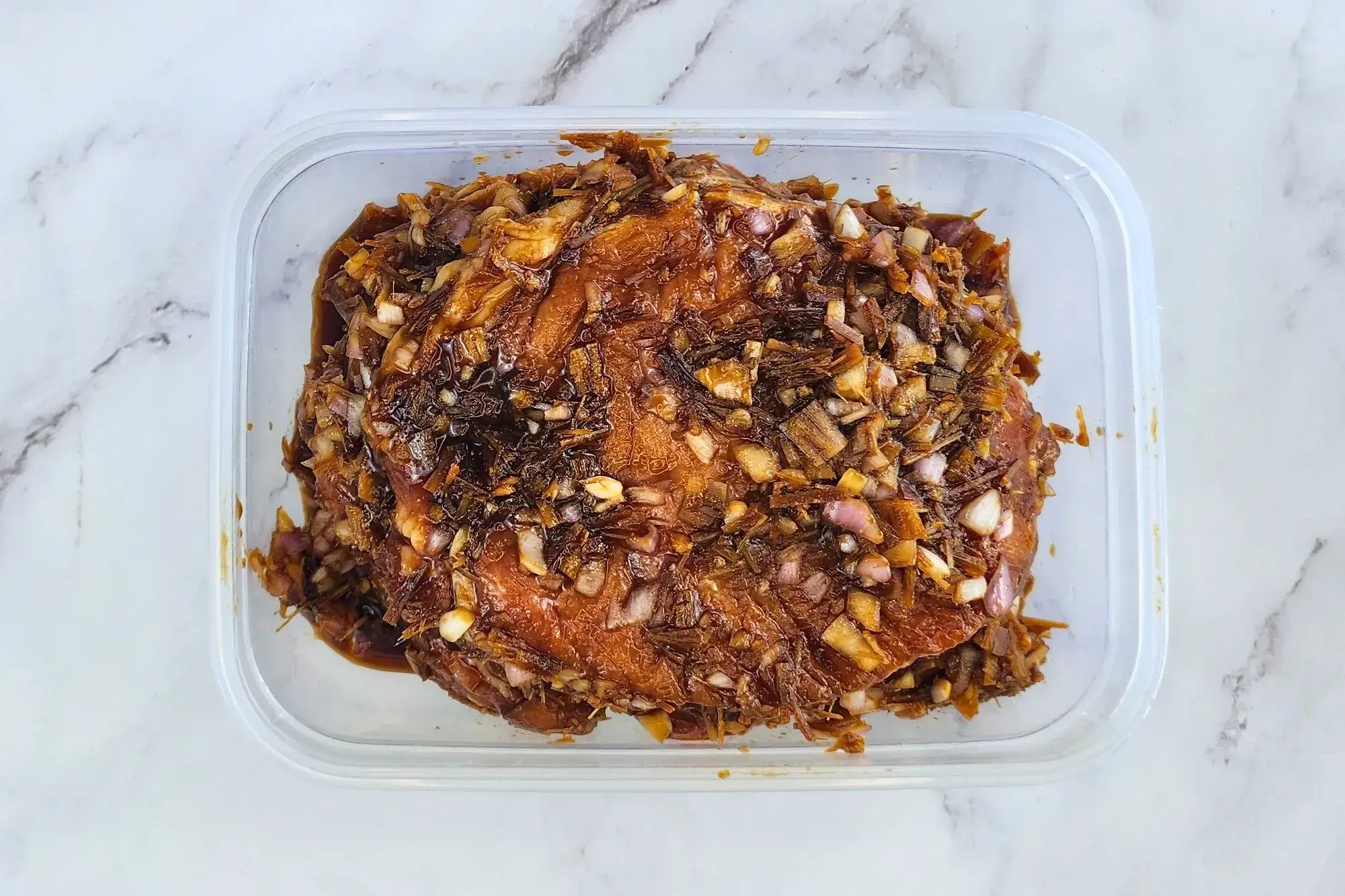 Marinated pork chops in a container