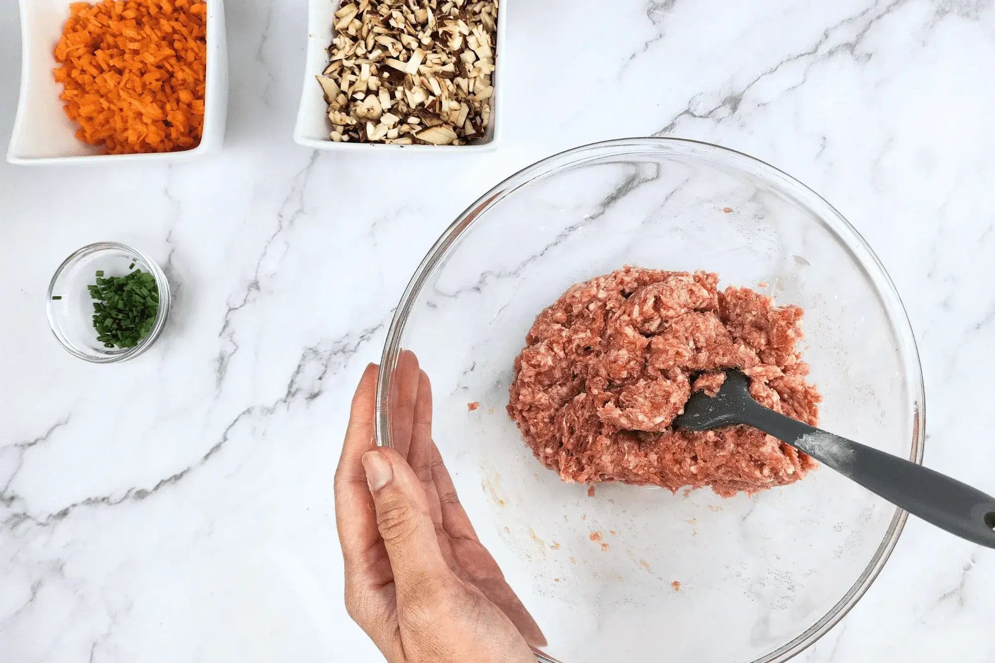 filling wontons in mixing bowl