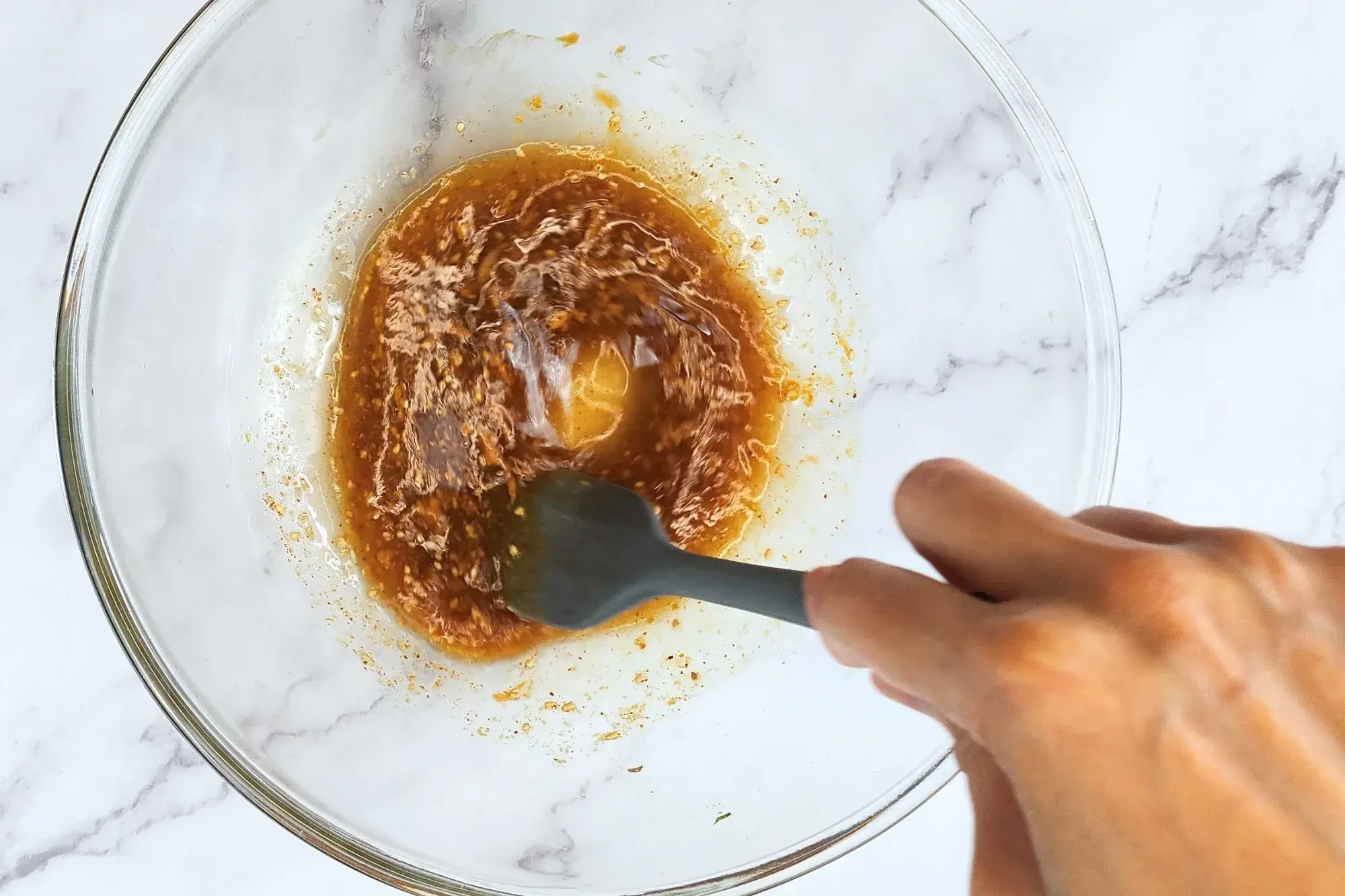 Mixing dressing salad in mixing bowl