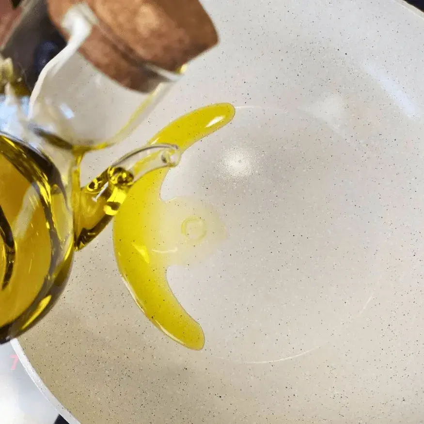 Oil being poured into a pan