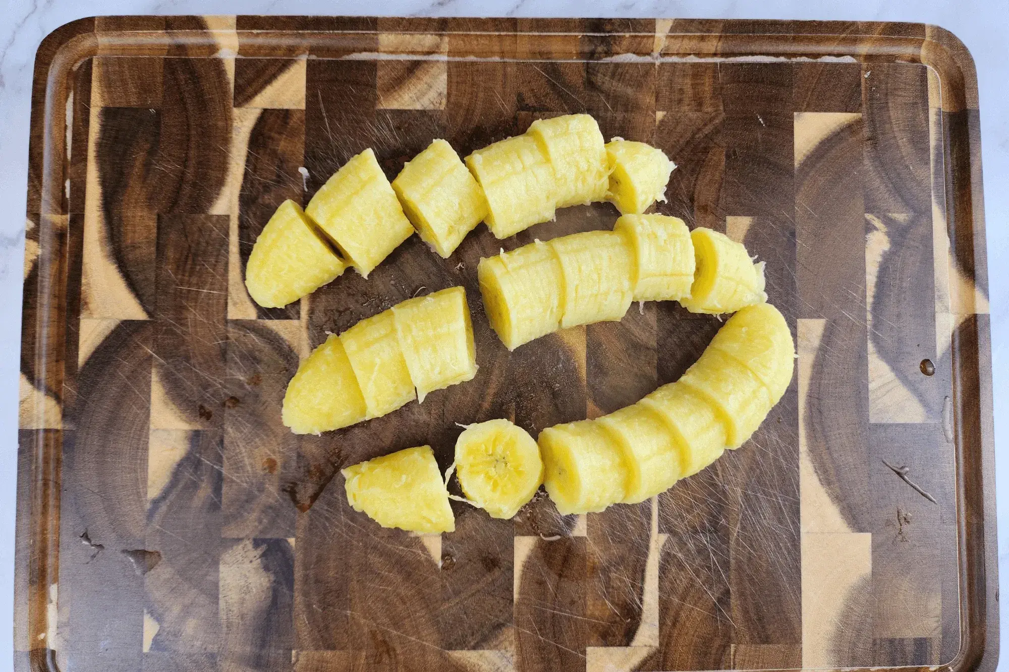 Peel the bananas and cut them into small cubes or bite-sized pieces.