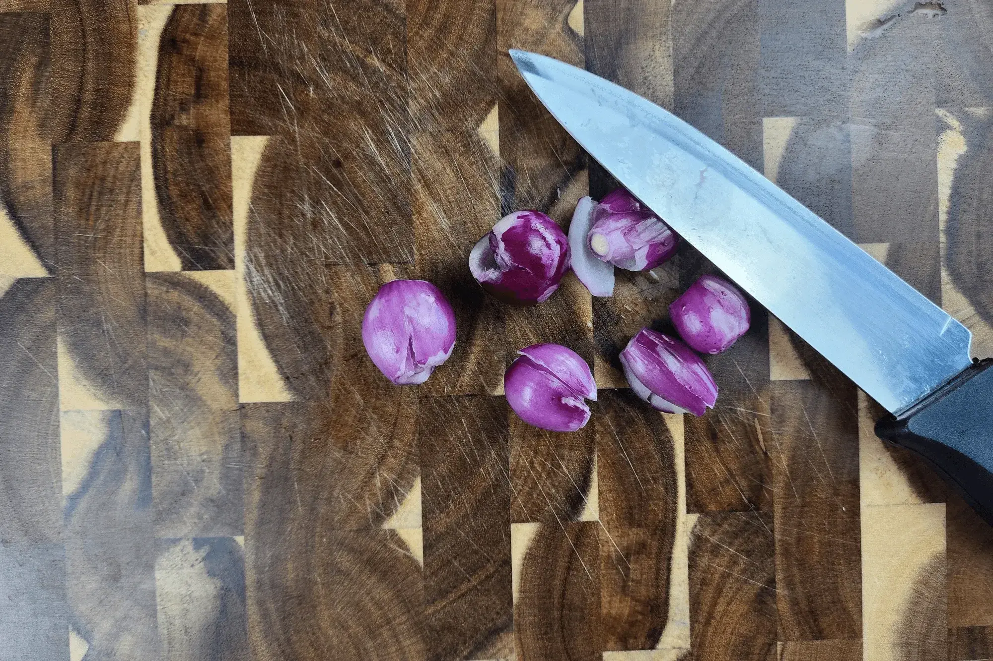 Peel the shallots and crush them gently to release their flavor