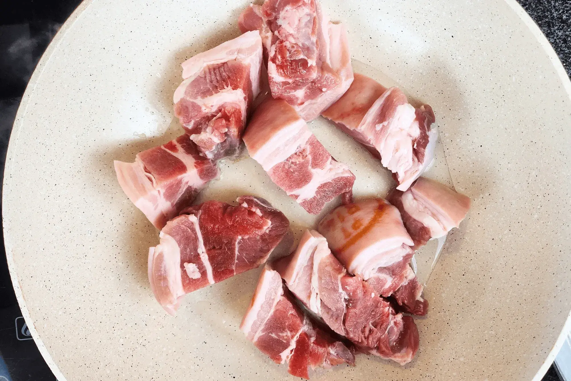 pork belly pieces in the hot wok