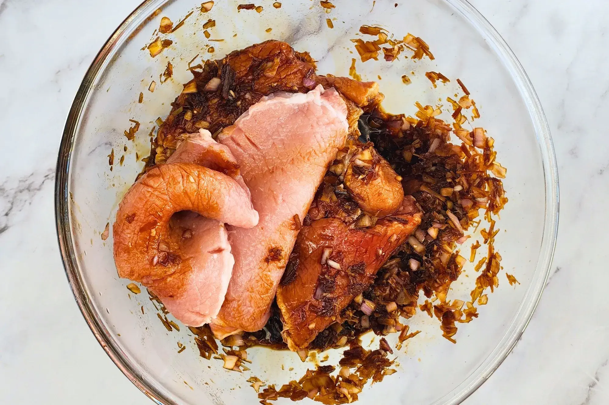 Pork chops in a mixing bowl