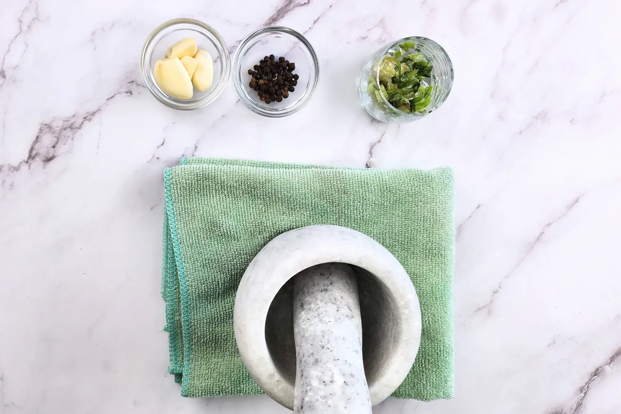 Pound cilantro roots, garlic, and black pepper