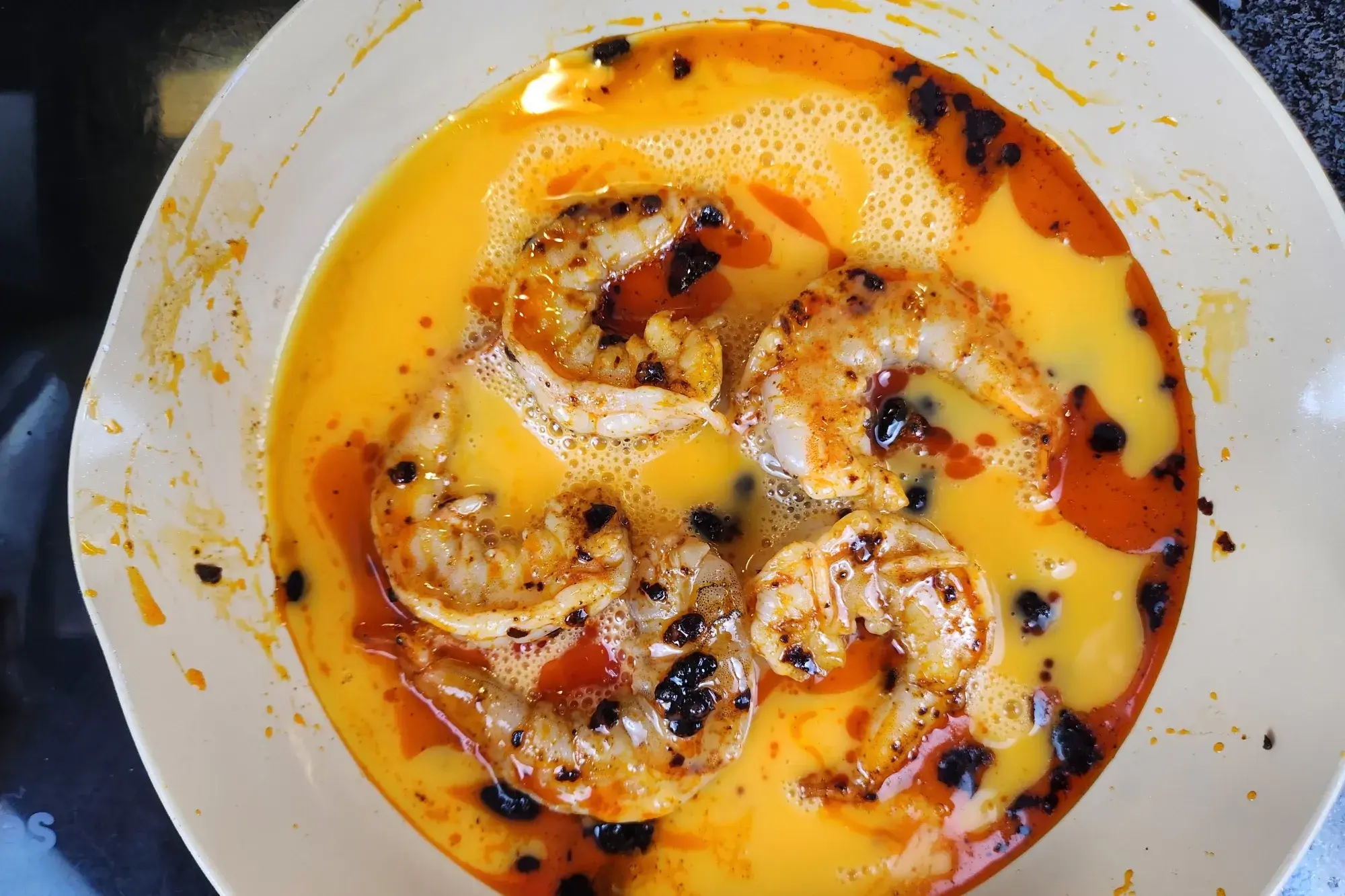 pour beaten eggs over shrimp