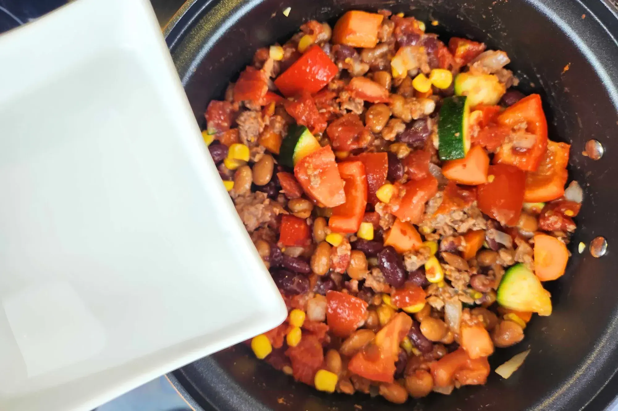 Pour in the water. Bring to a simmer