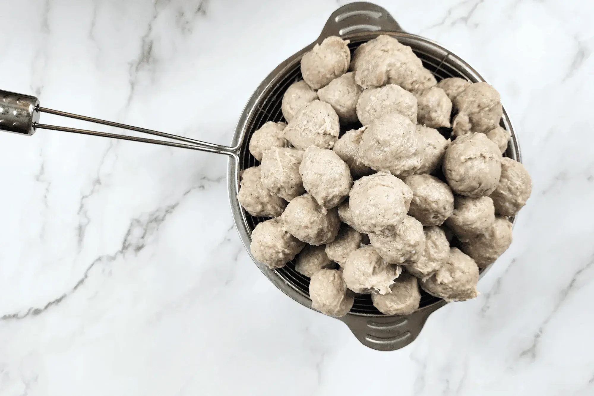 Remove the meatballs and place them in a colander to drain off the water completely.