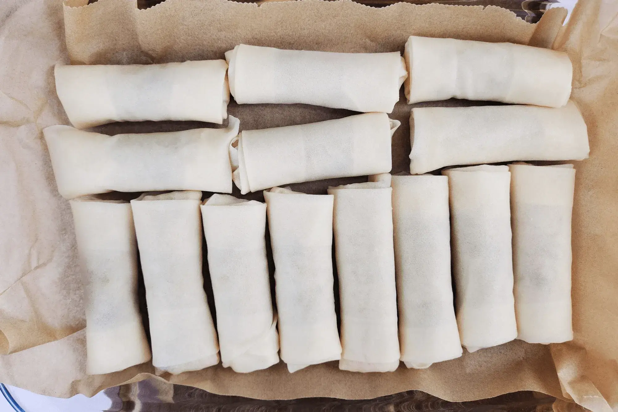 Repeat until all the spring rolls are wrapped.
