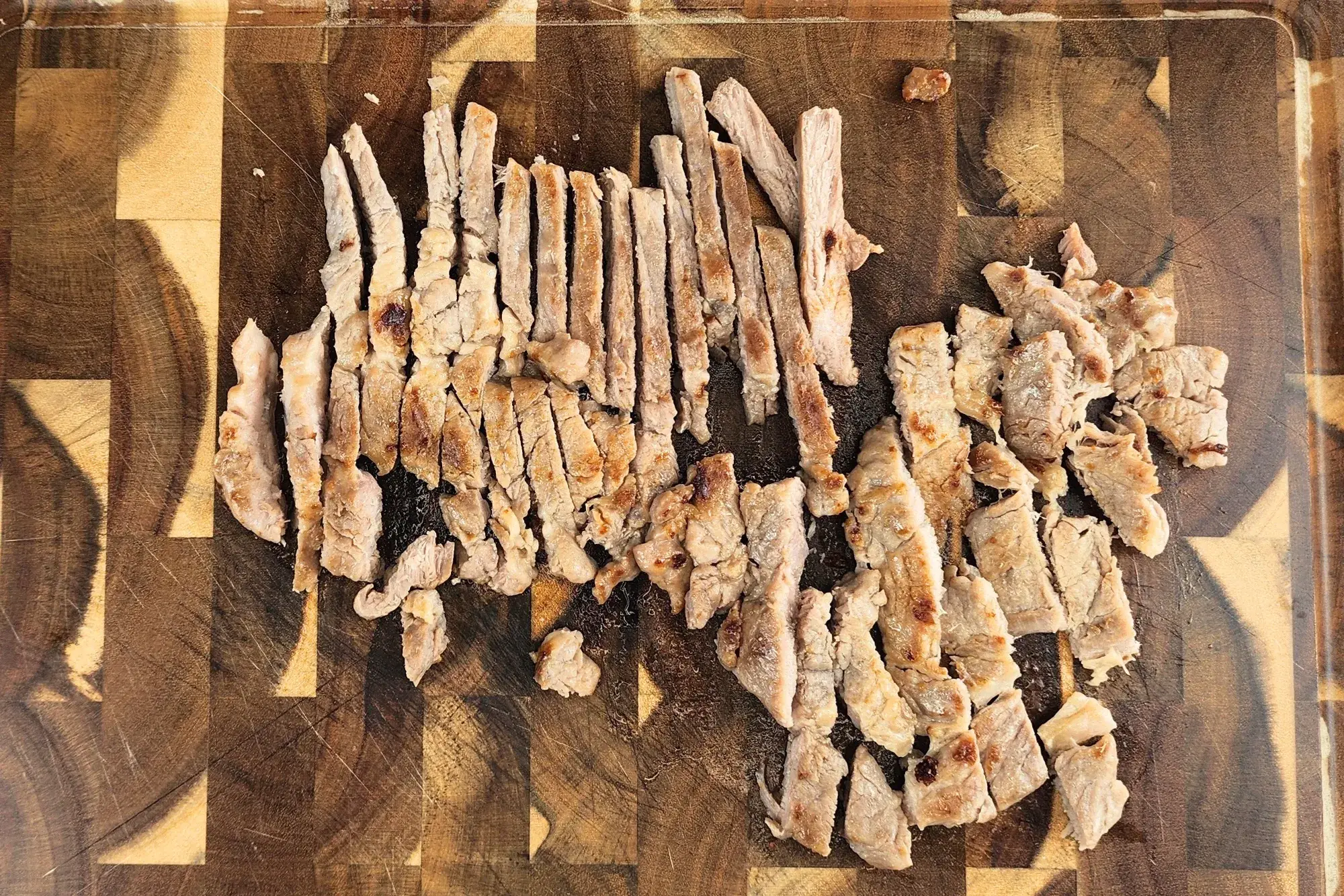 slice grilled pork into bite-sized pieces.