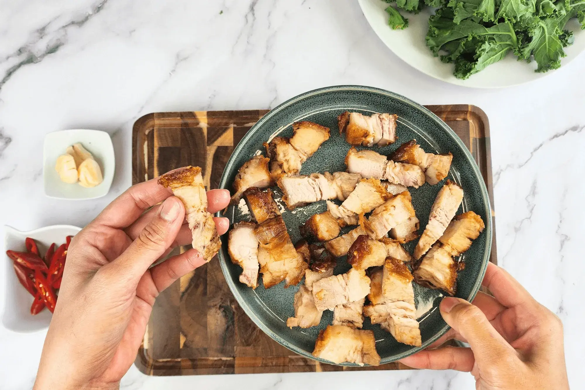 Slice the crispy pork belly into bite-sized pieces.