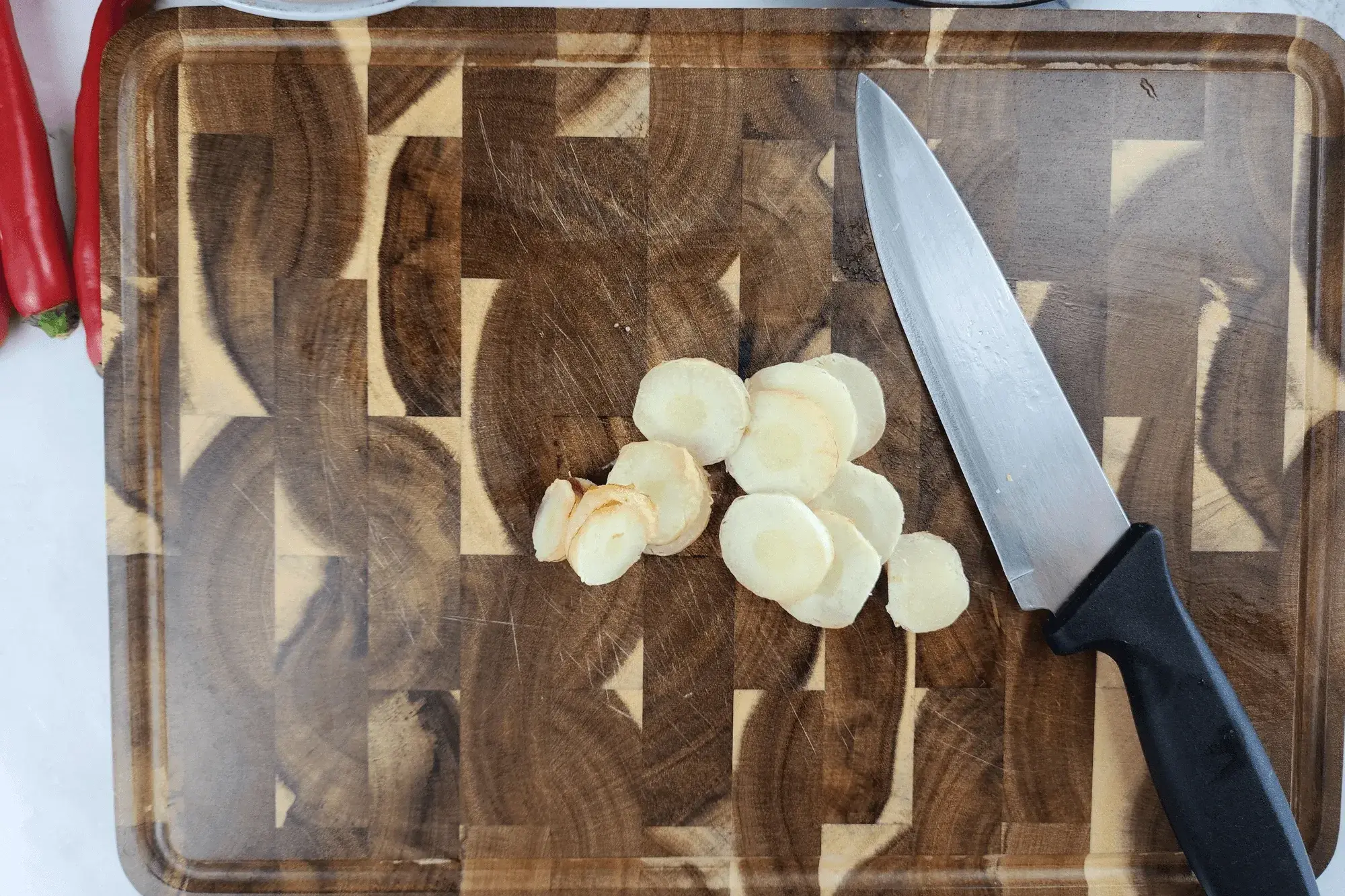 Slice the young galangal into thin rounds. 