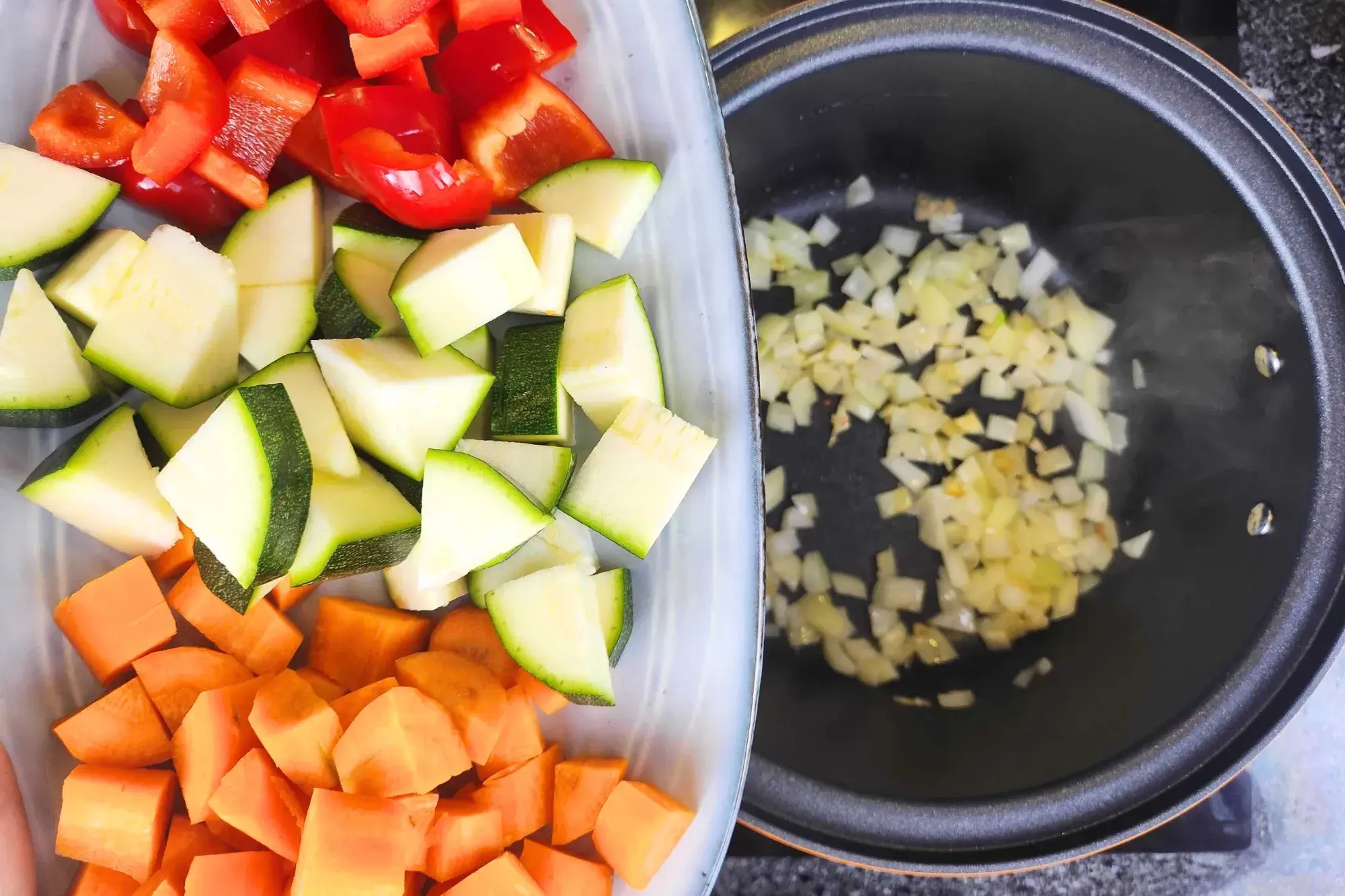 Stir in the carrots, courgette (zucchini), and red pepper.