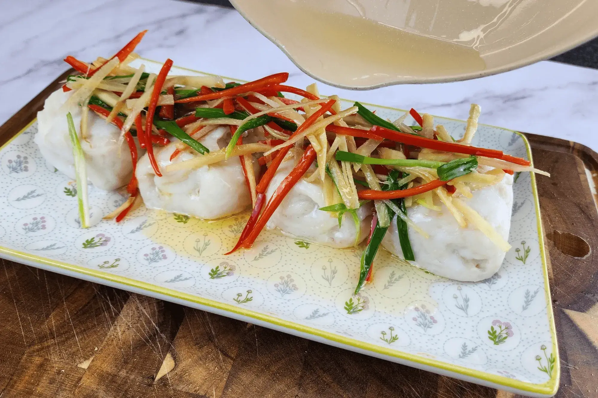  then pour the hot oil over the fish with the vegetables on top 