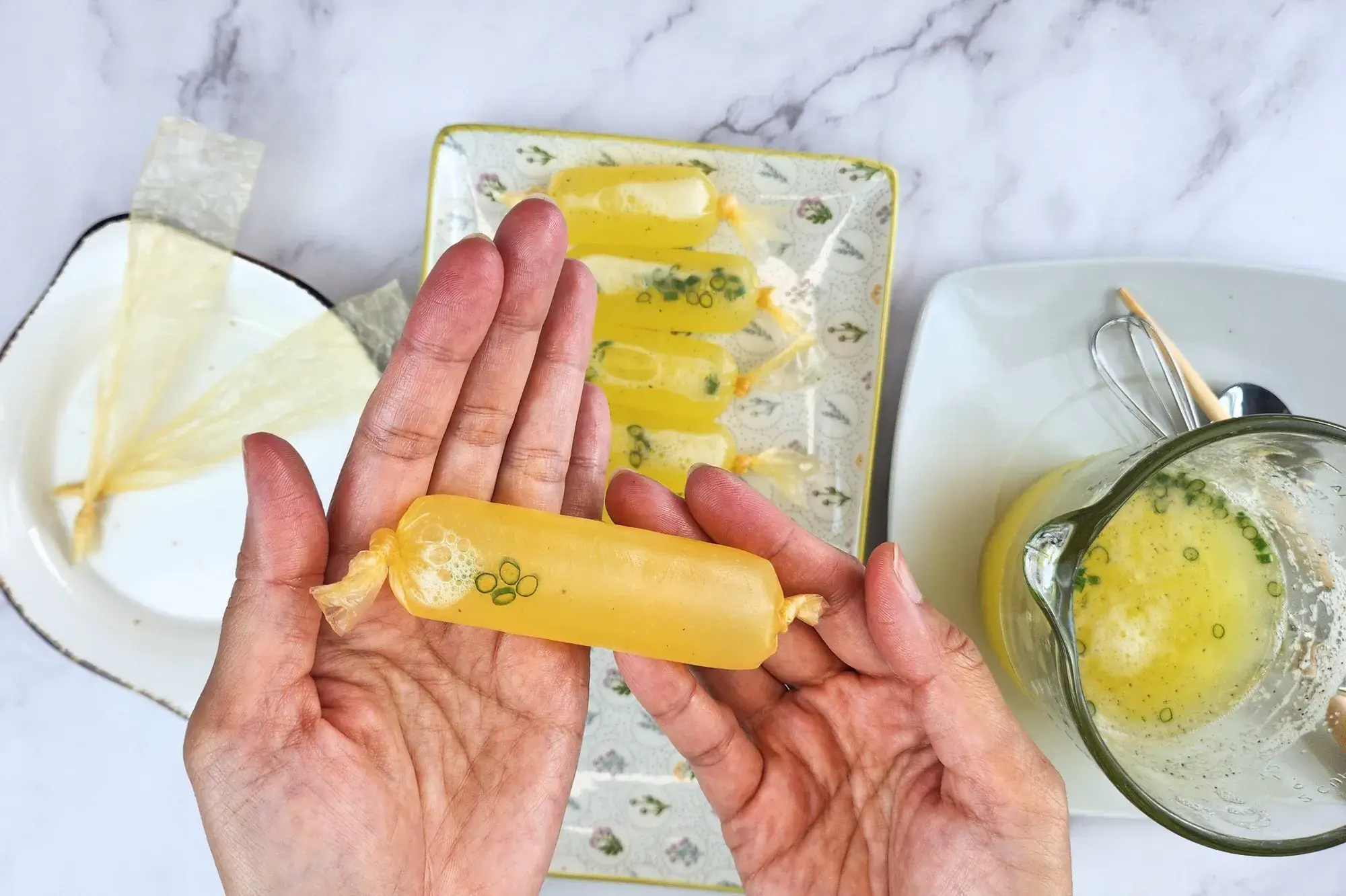 Two hand holding uncooked sausage