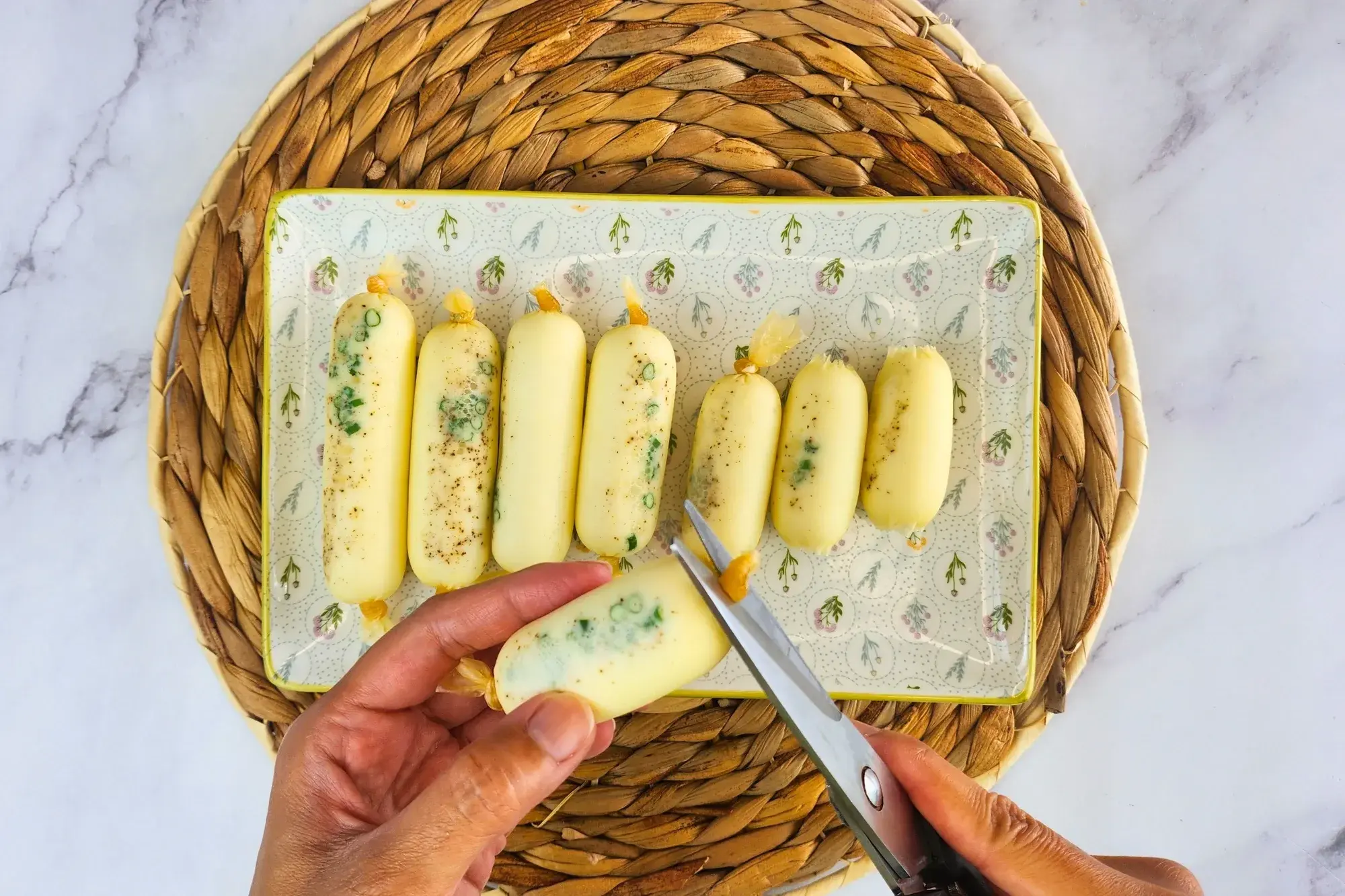 Two hand using scissors cut the end of sausage